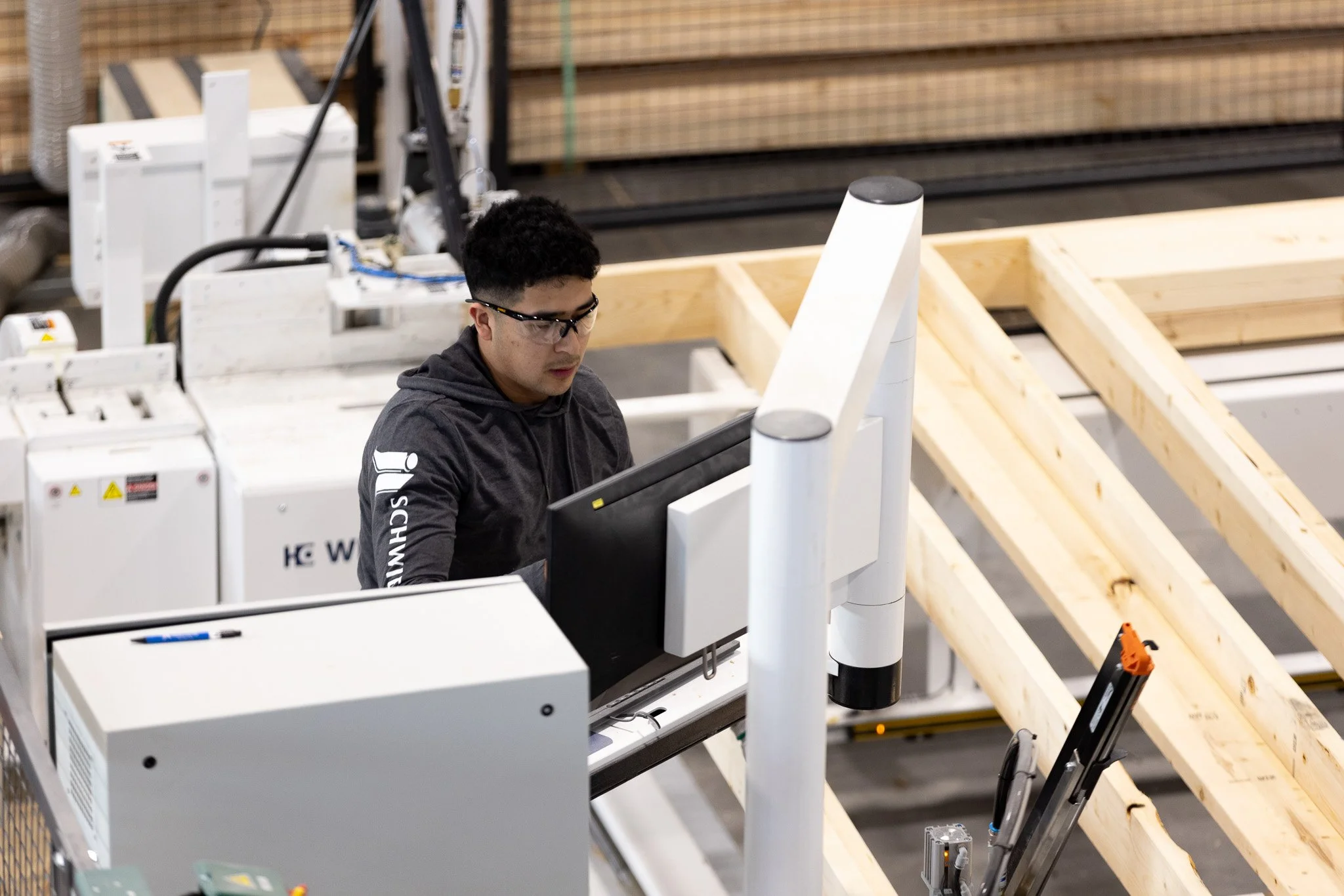 Wall panels being assembled in climate-controlled minnesota manufacturing facility