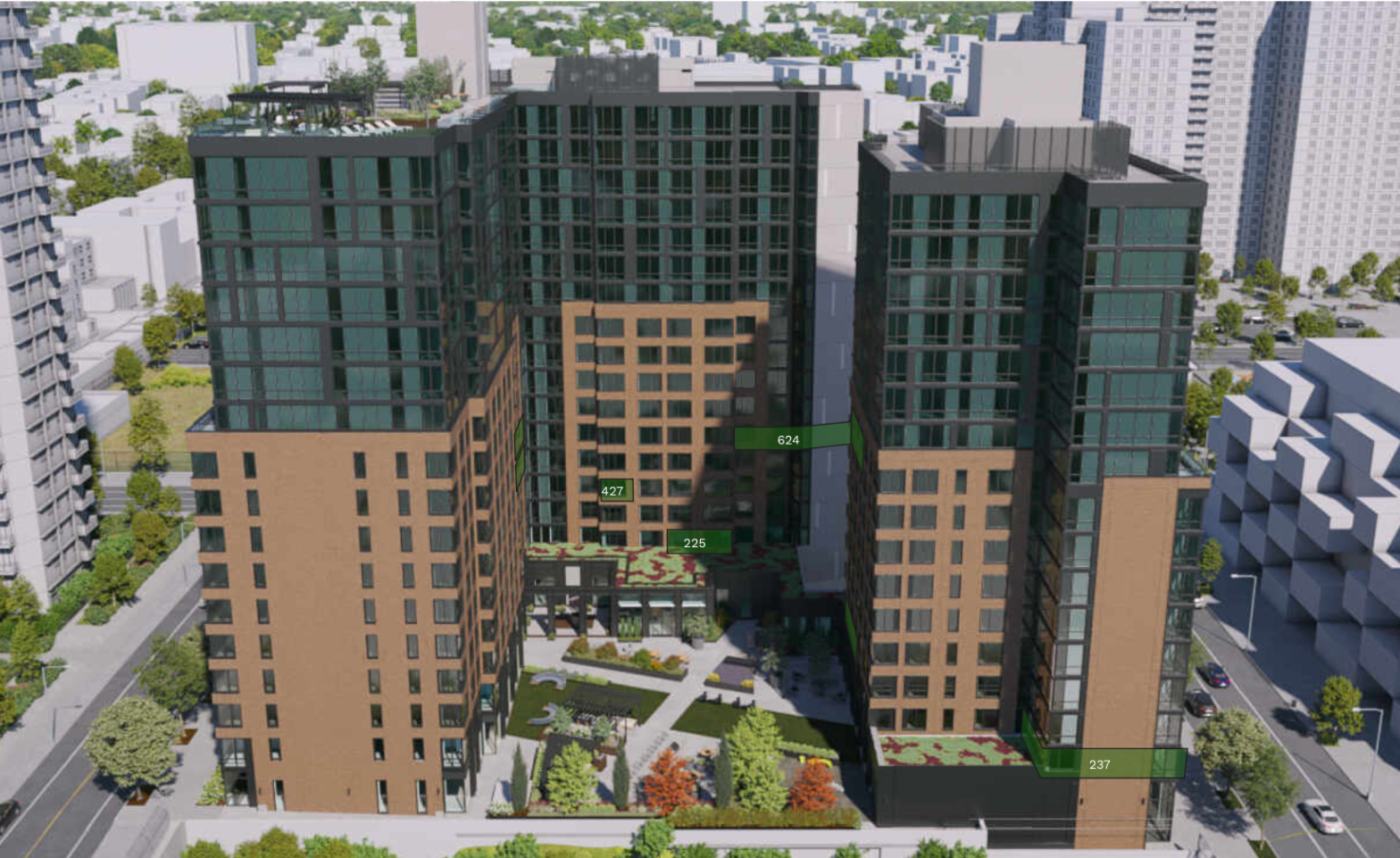 Aerial view of modern high-rise residential building with landscaped courtyard, surrounded by other tall buildings and green trees.