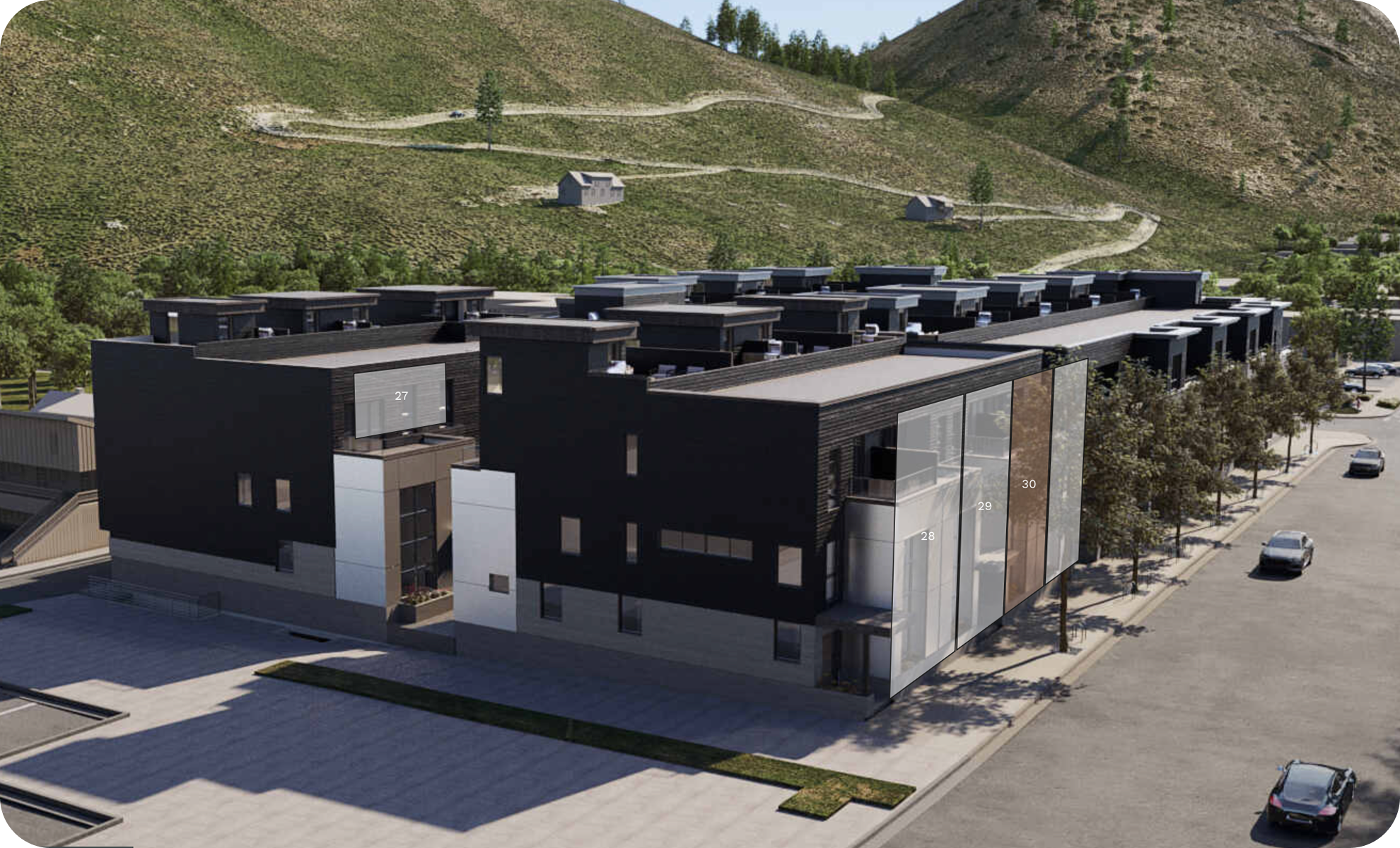 Modern apartment building with black and white exterior, surrounded by trees and parked cars, with hills and a winding road in the background.