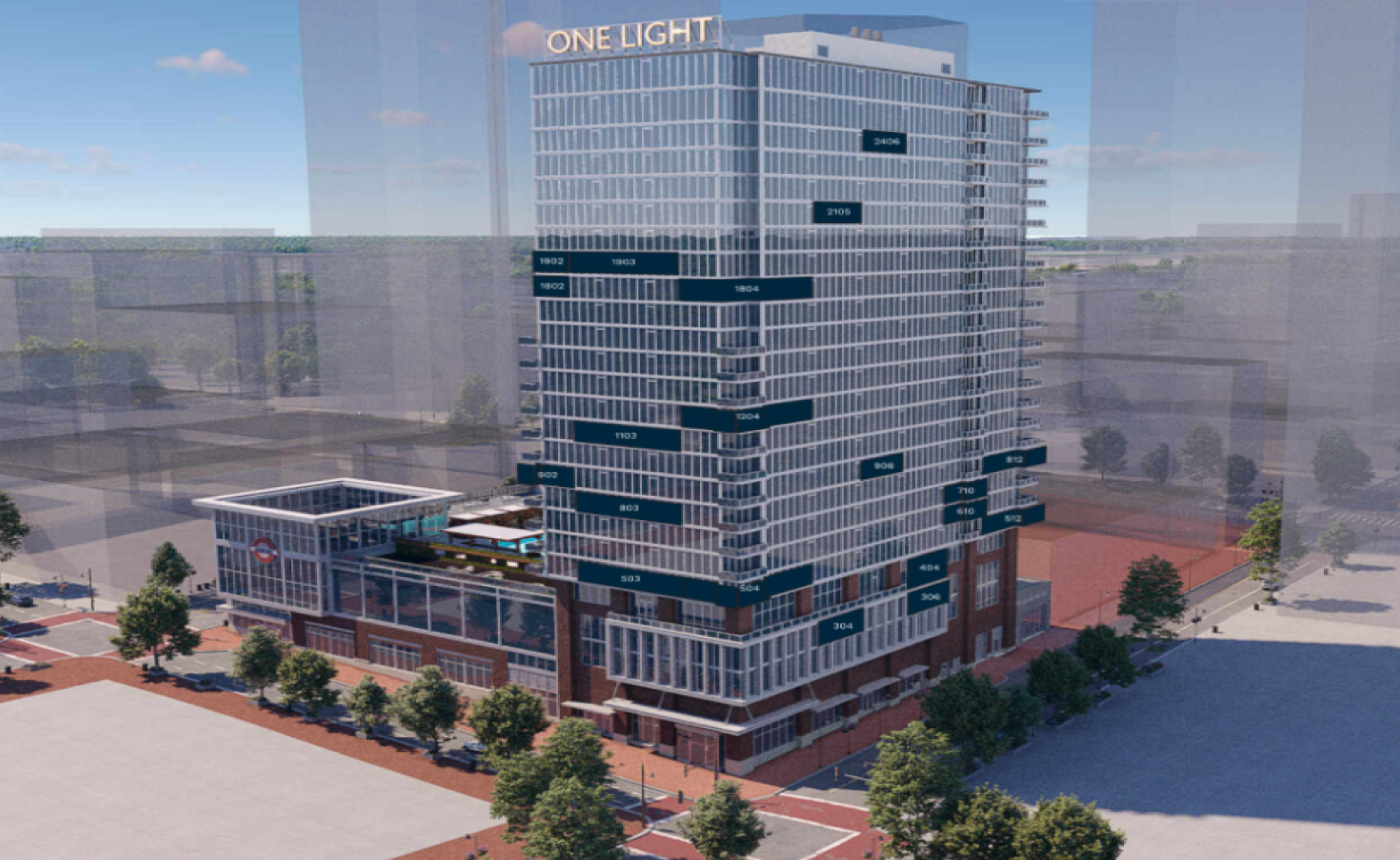 A modern glass and brick high-rise building with labels indicating various floors and sections, with a rooftop terrace, near a subway station, with parking and trees in the surroundings.