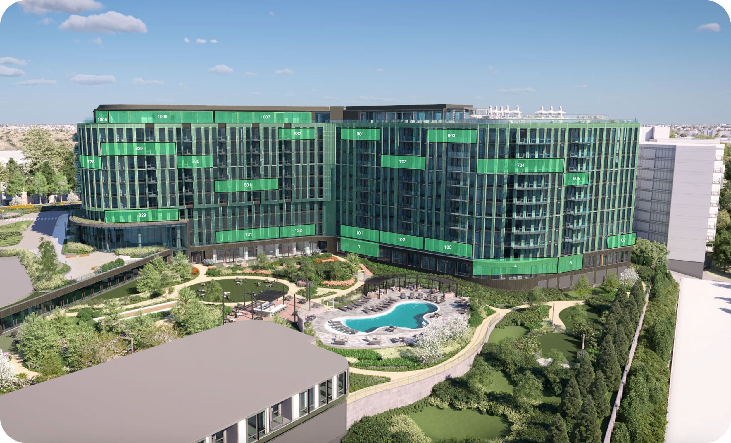 A large modern building with a green glass exterior, surrounded by a landscaped area with trees, bushes, and a swimming pool. The building features numbered green labels on the windows.