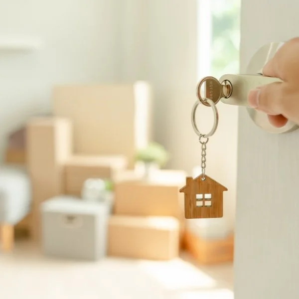 Moving boxes and house key representing downsizing and move preparation services in Brentwood TN