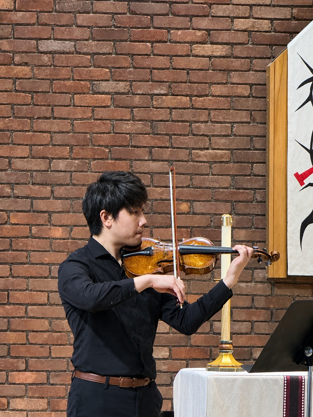 Violinist Performing Before a Brick Altar.png
