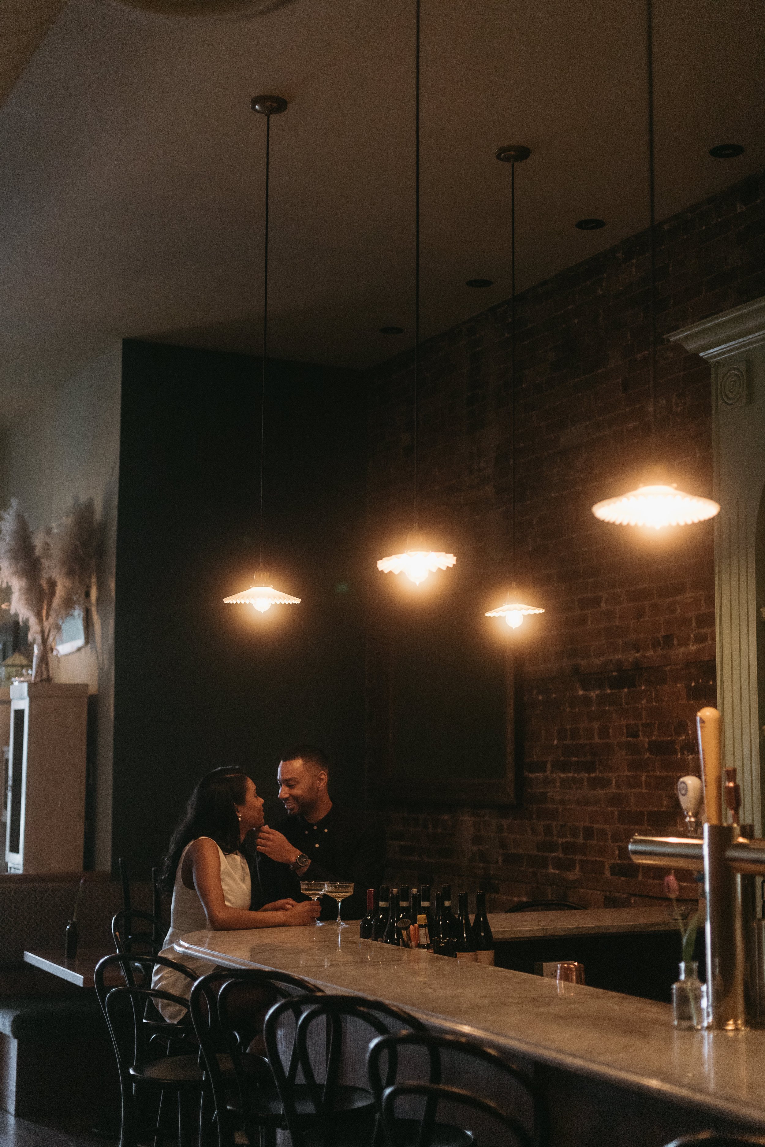 Couple flirt for engagement photos at Cantina Gia in Ottawa, Ontario