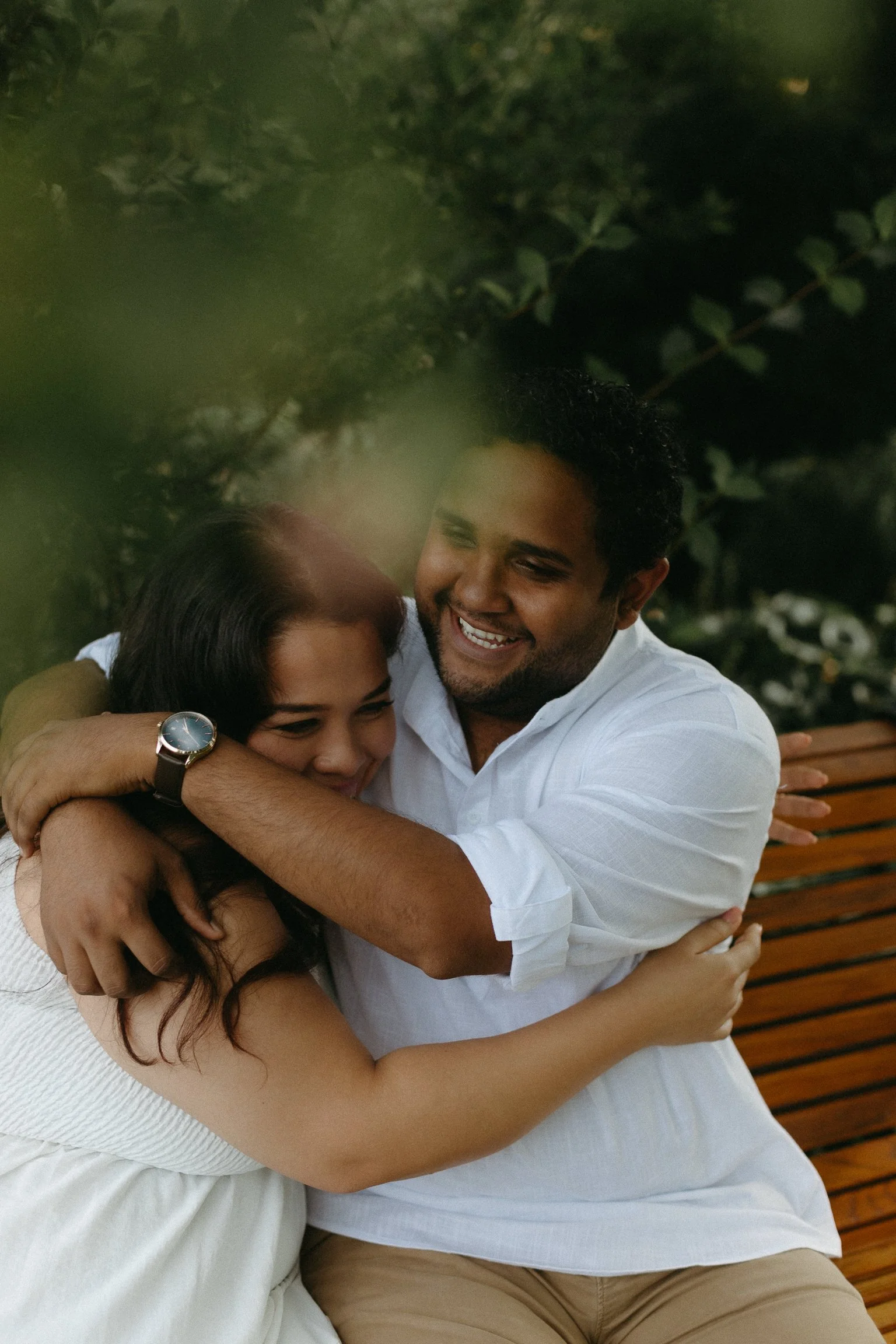 Engaged couple laugh and hug at the Ornamental Gardens in Ottawa, Ontario