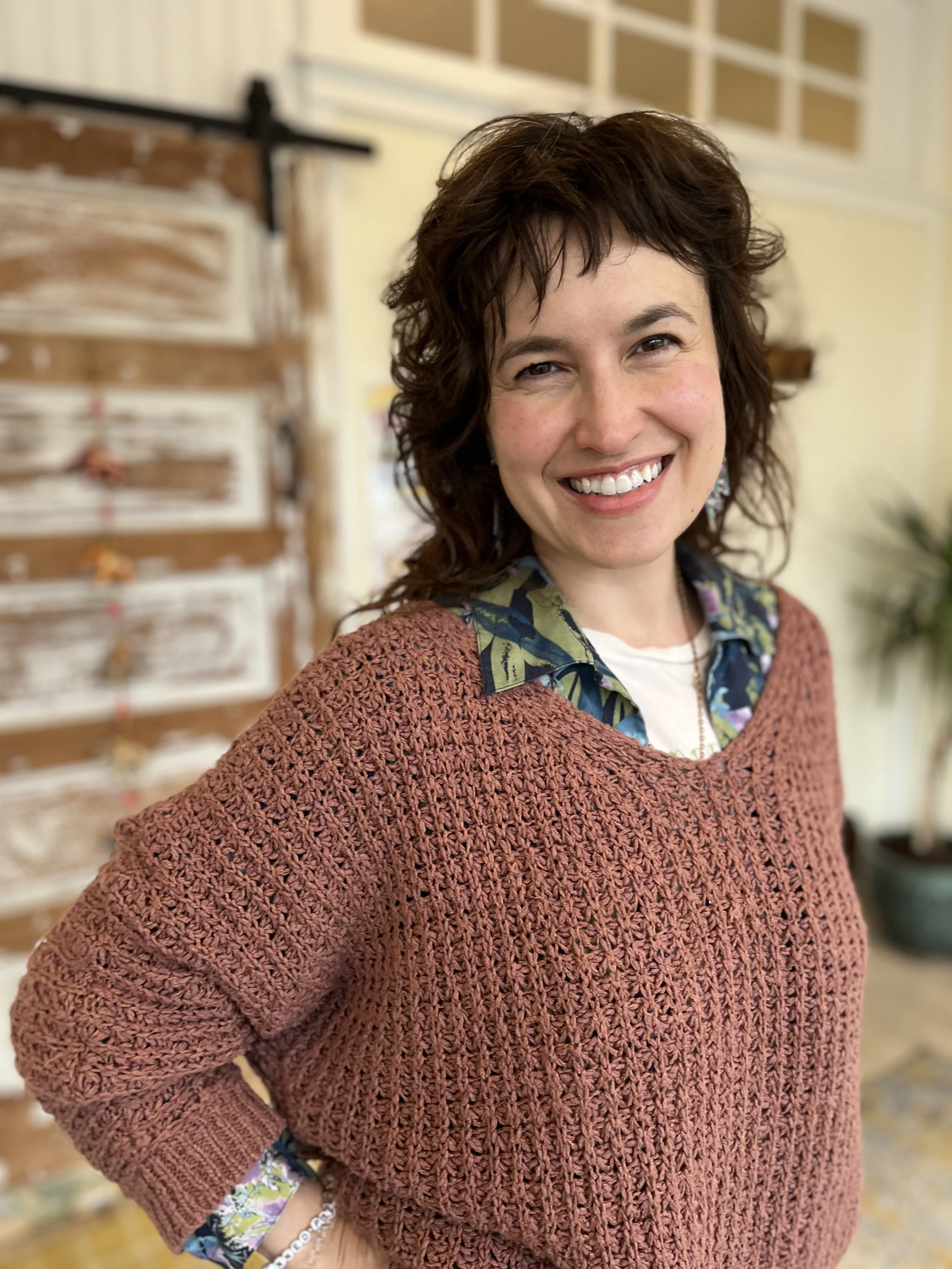 Kate Brennan smiles in a yoga studio.