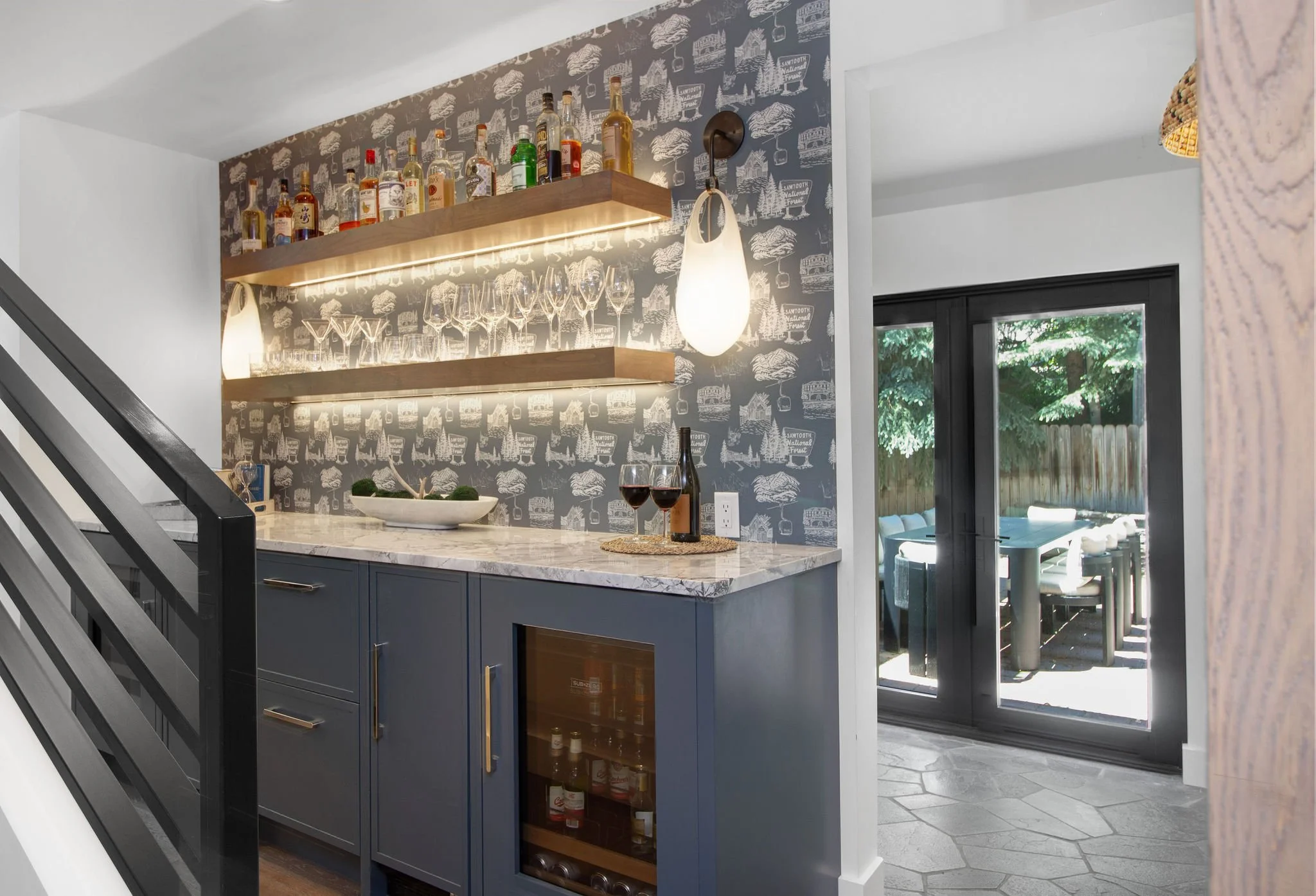 Throughout the renovation, every room was updated to meet the expectations of modern luxury living. New flooring, lighting, windows, doors, and custom built-ins bring consistency and warmth to the interiors while framing the home's spectacular Warm S