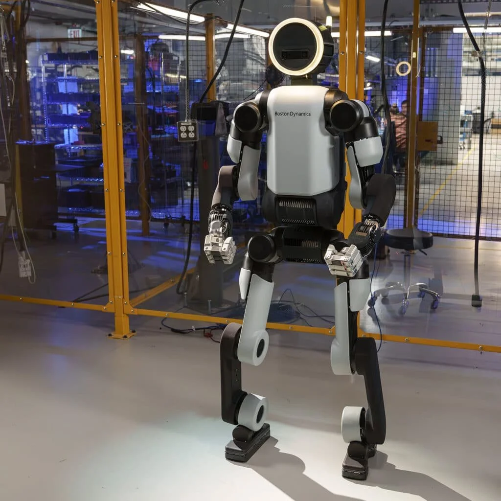 Boston Dynamics Atlas humanoid robot standing in a robotics testing facility.