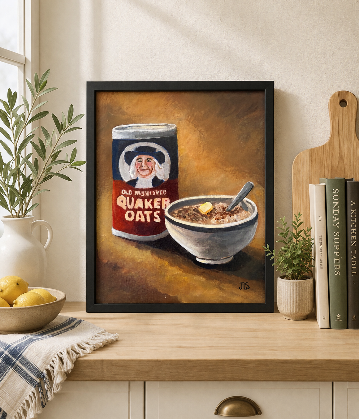 framed Quaker oats container with bowl of oatmeal and butter on a table