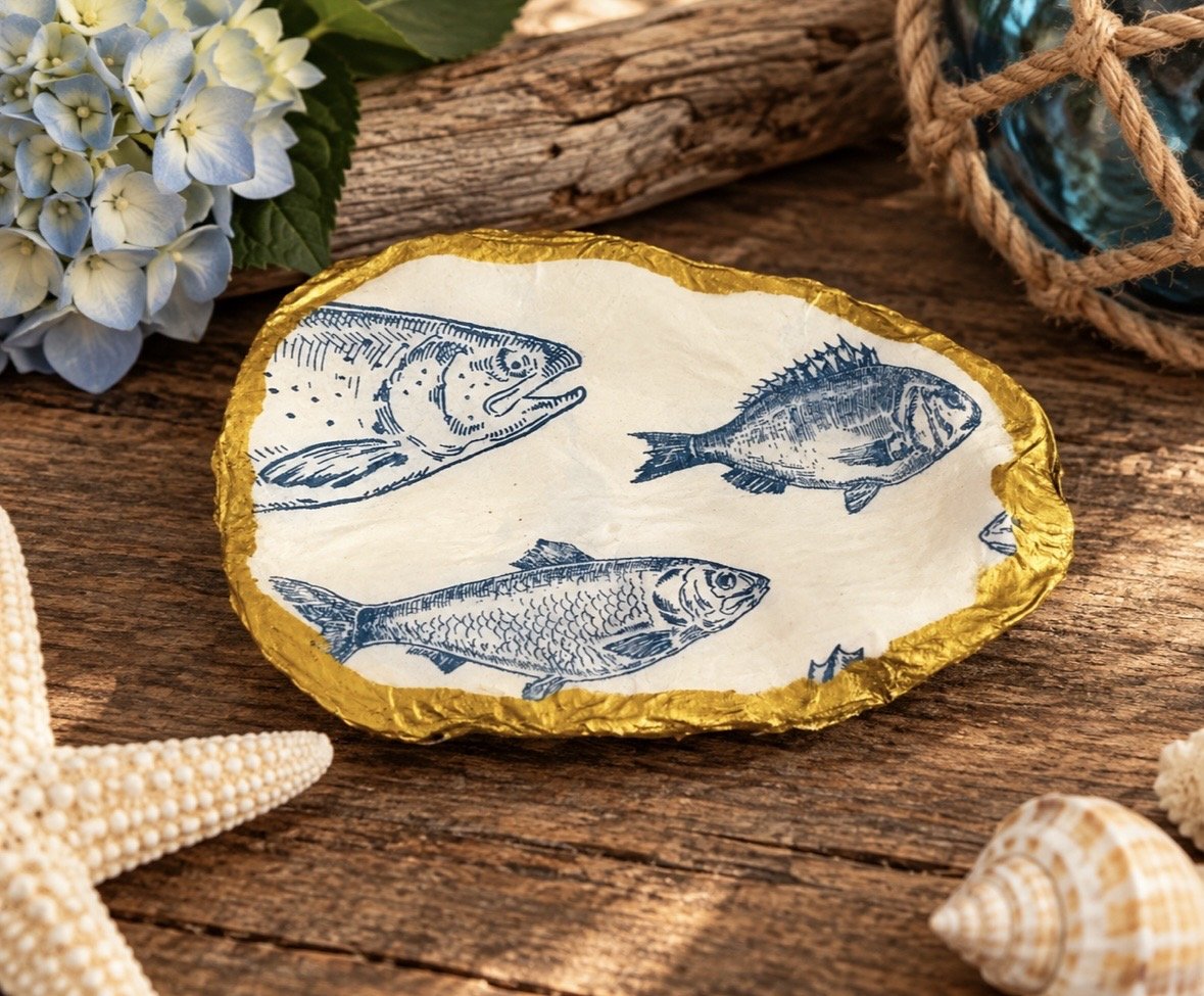 Blue Fish — Decoupage Oyster Shell Trinket Dish  Product Description  A beautiful coastal-inspired trinket dish handcrafted from a natural oyster shell. Featuring vintage-style