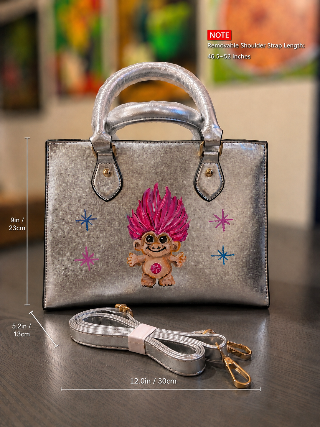Metallic silver hand-painted troll doll purse with removable shoulder strap, gold-tone hardware, and bright pink hair.