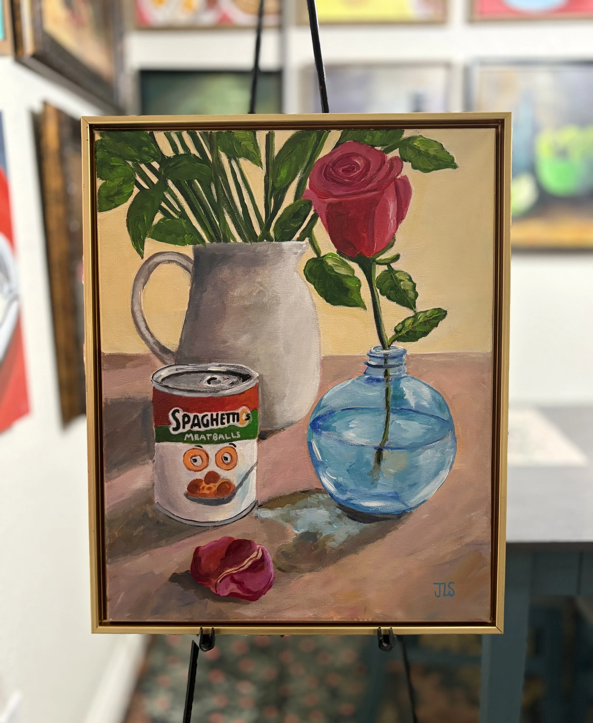 Painting of a red rose, blue glass vase, and SpaghettiOs can in an original acrylic still life painting by Jane L. Sayers.