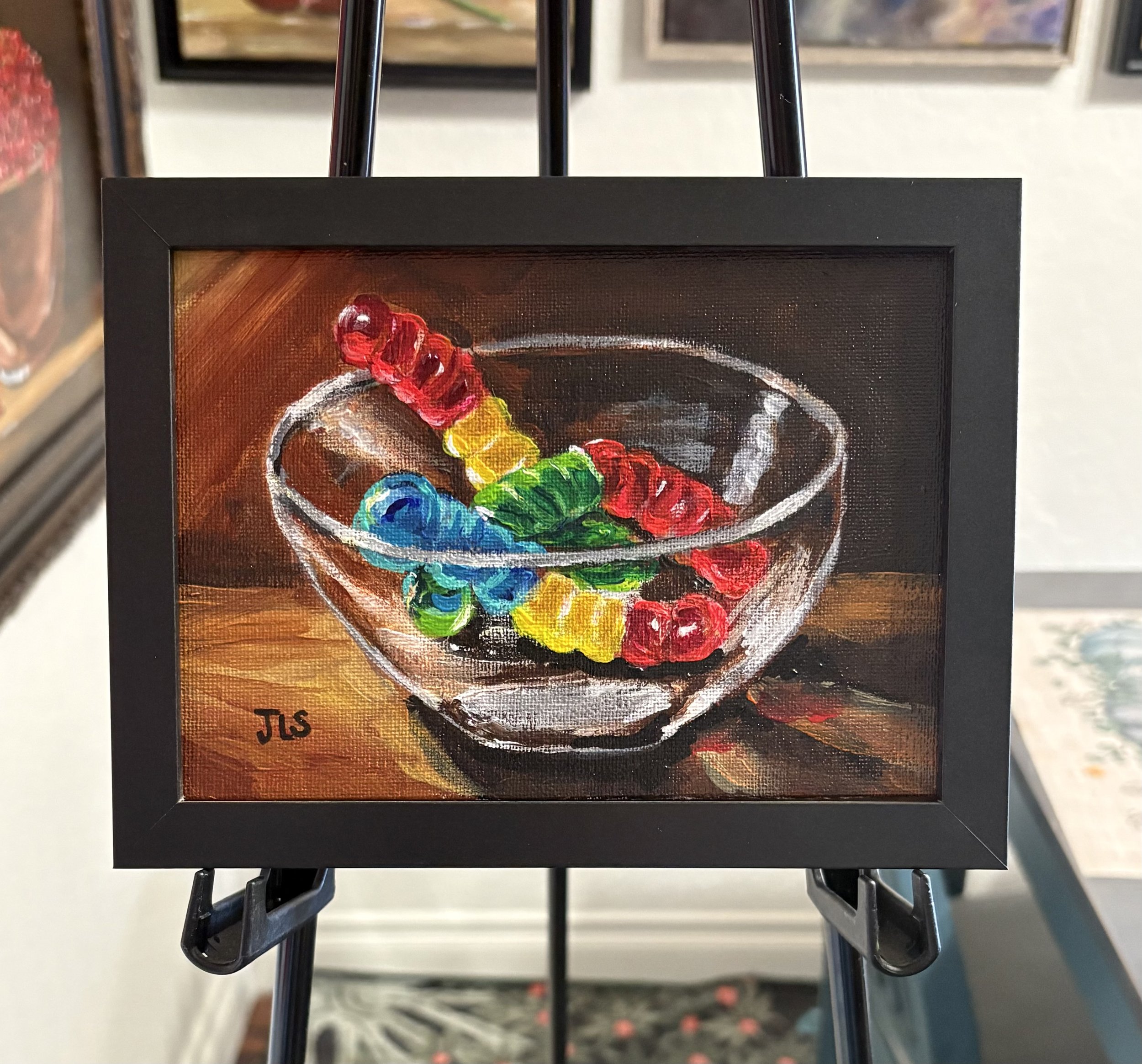 Gummy Worms original hand painted acrylic candy still life by Jane L. Sayers featuring colorful gummy worms in a glass bowl against a dark moody background
