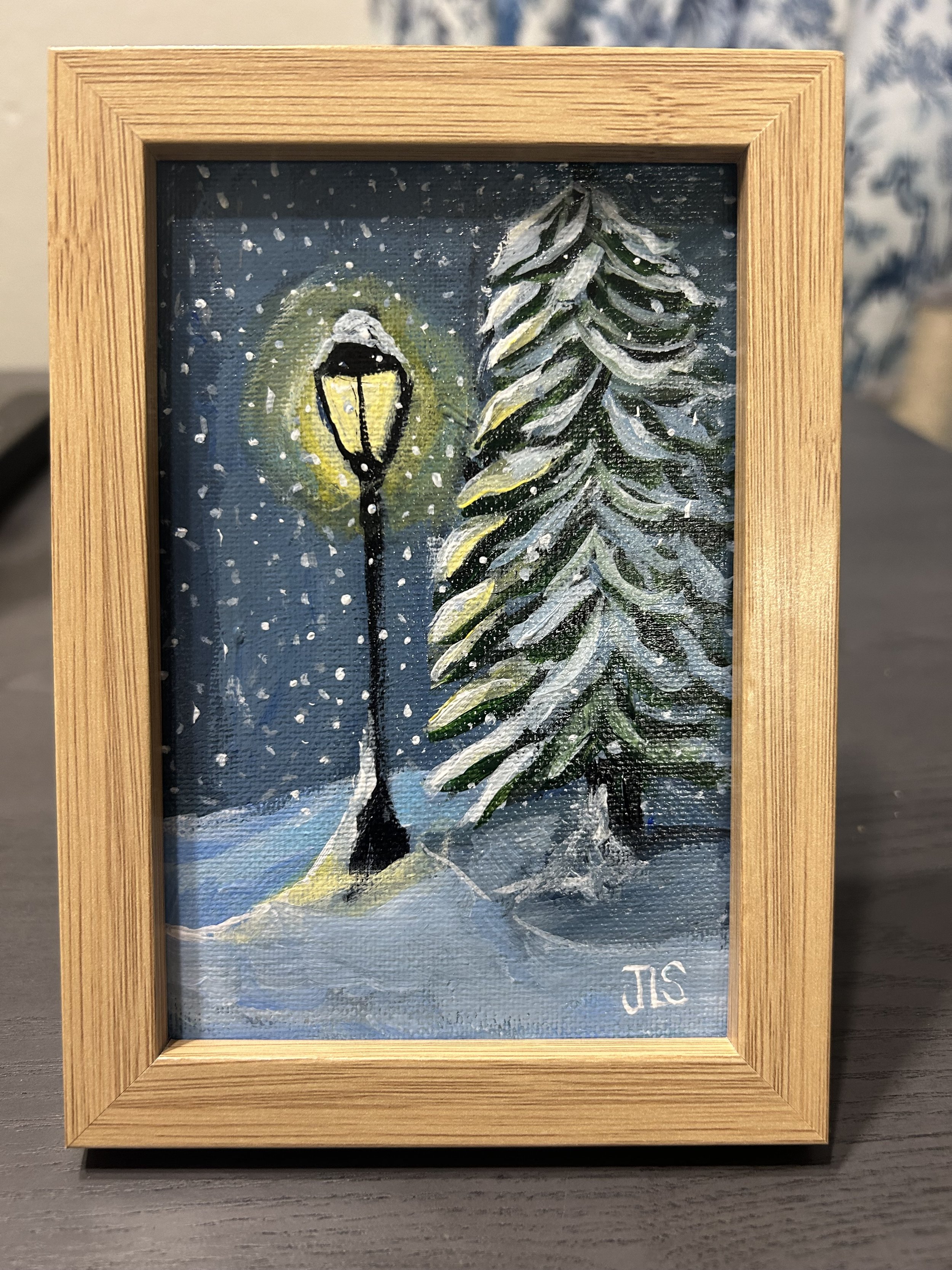 classic snowscape artwork with latern and trees