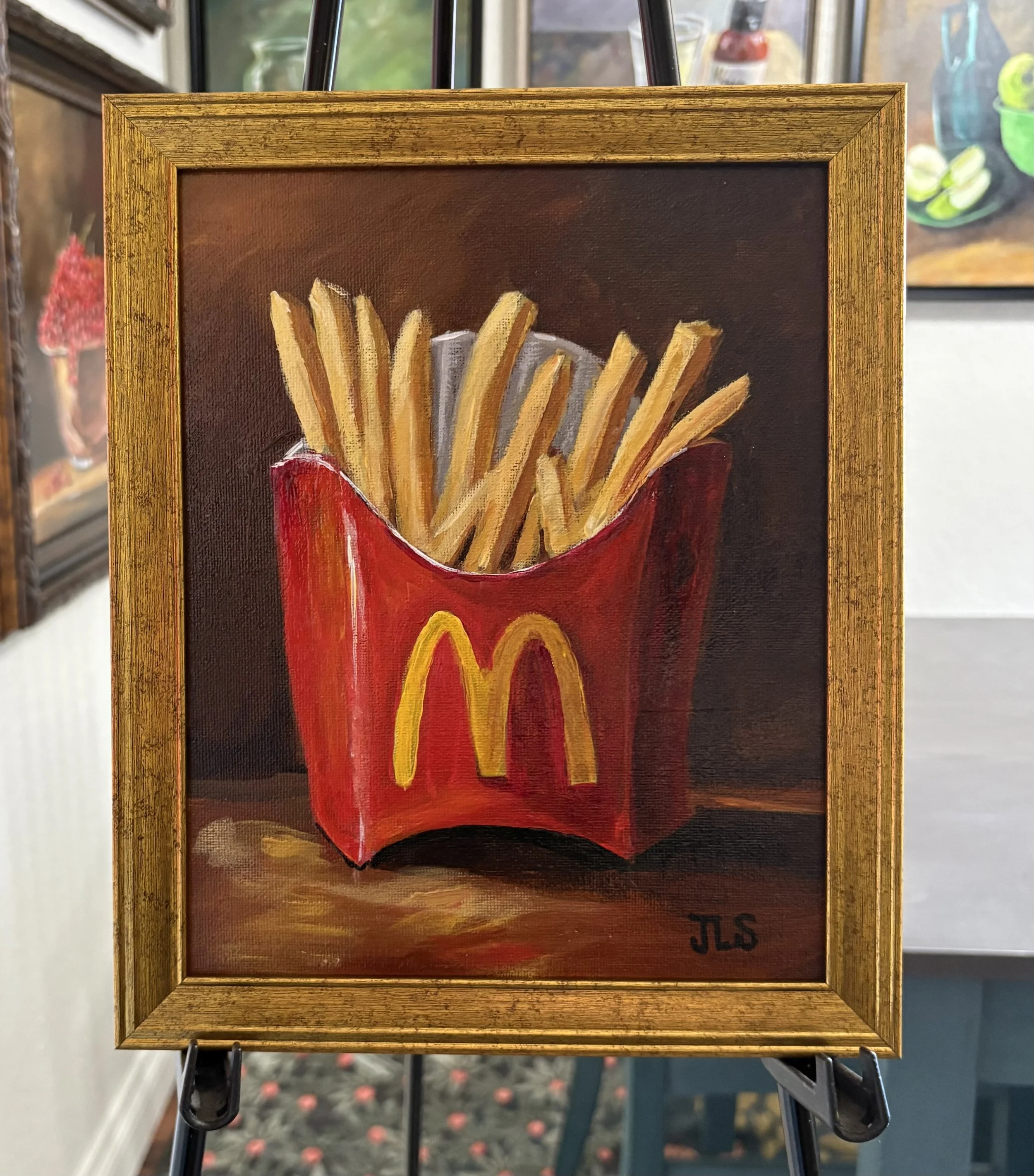 Painting of McDonald’s French fries in the classic red carton, hand painted in acrylic on an 8 x 10 canvas panel and framed in a gold wood frame.