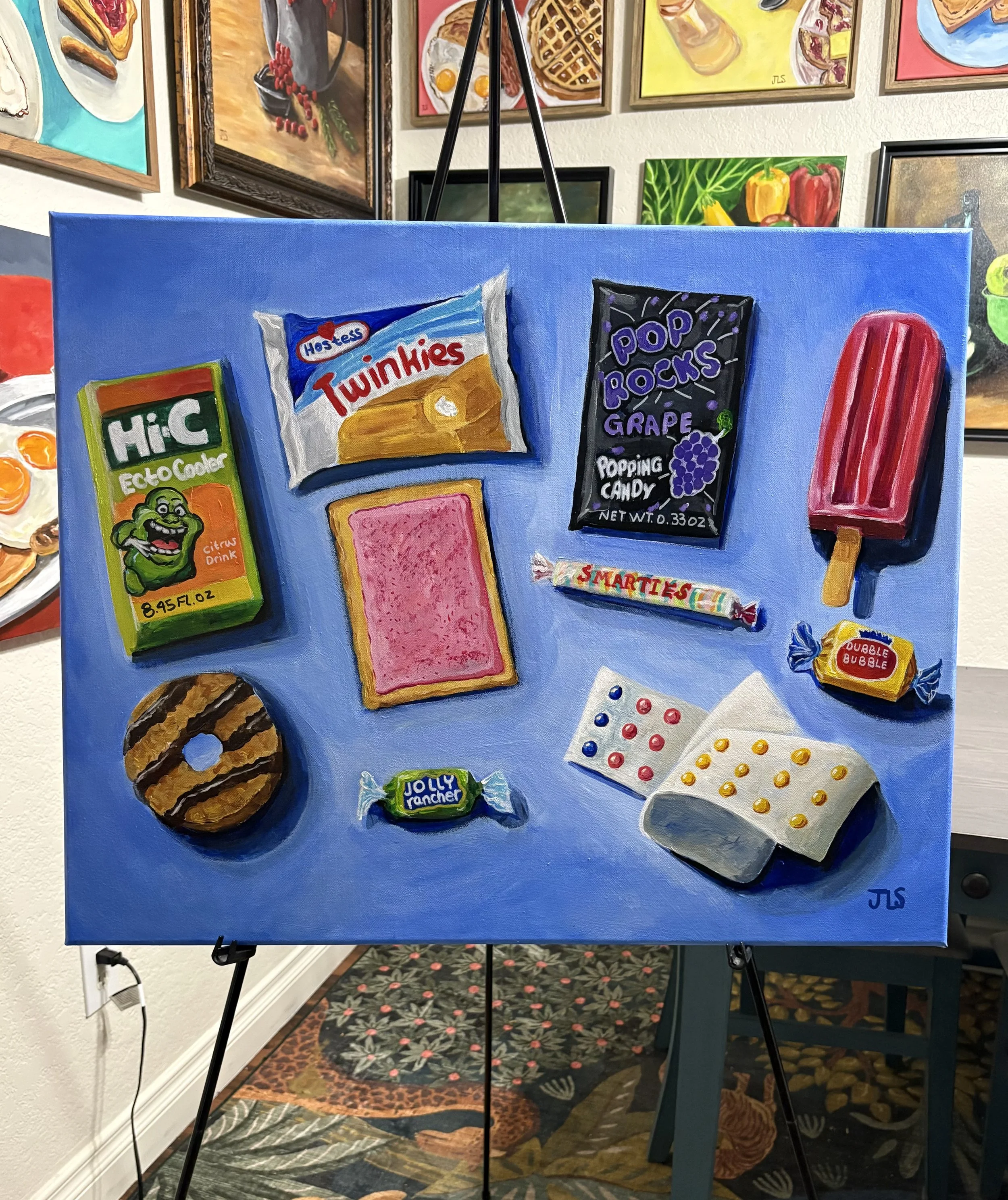 Painting of nostalgic childhood snacks and candy, including Hi-C, Twinkies, Pop Rocks, Smarties, cookies, Rice Krispies Treats, and other retro favorites arranged against a bright blue background.