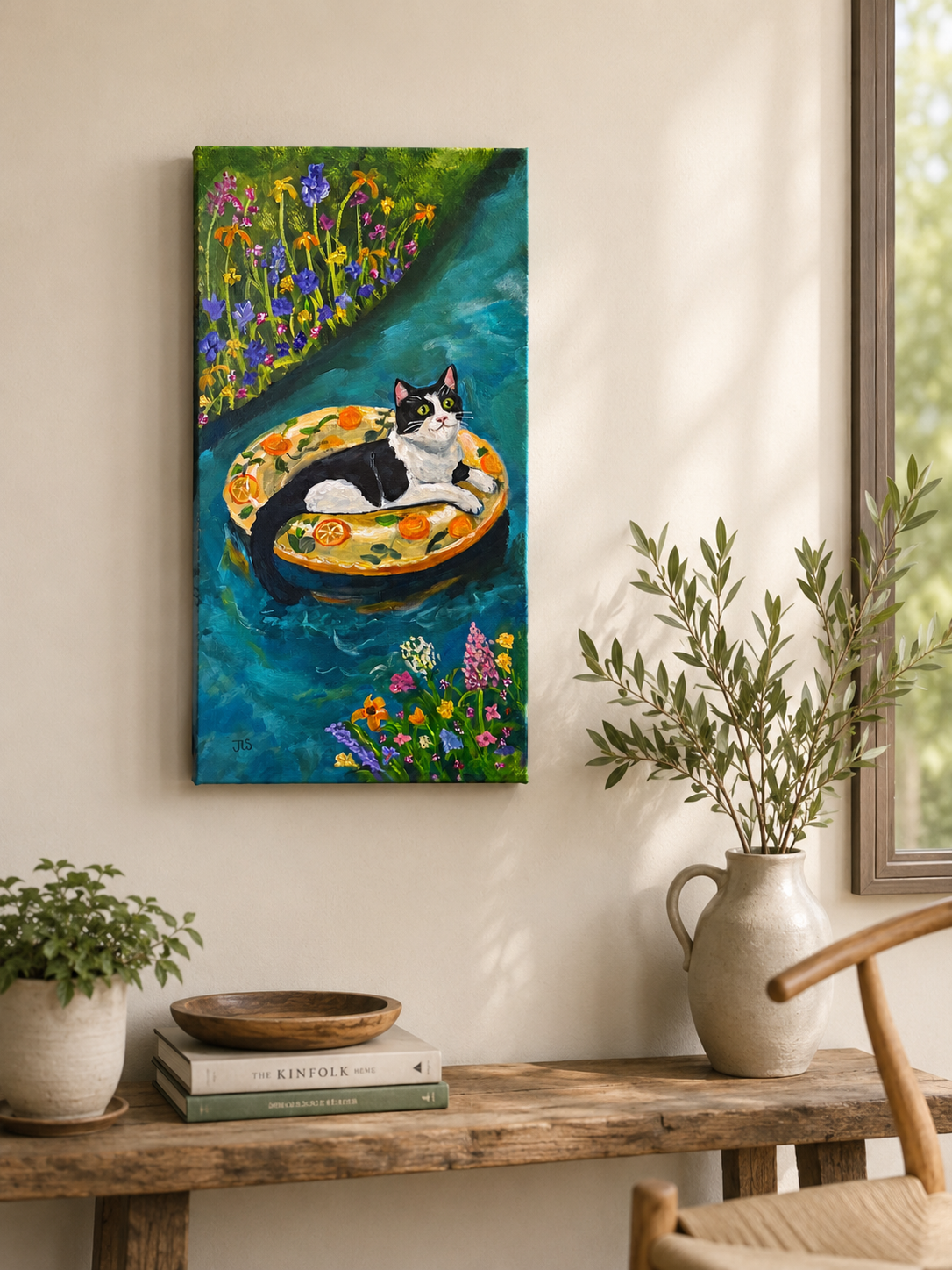 Black and white cat lounging on a citrus-patterned float in blue water surrounded by colorful wildflowers and summer blooms
