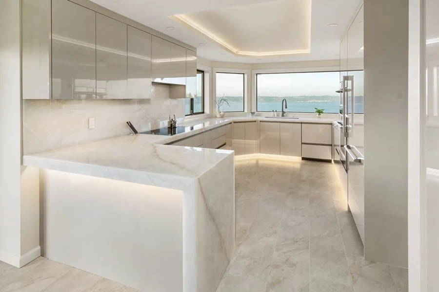 Luxury kitchen remodel in Tacoma, Washington with waterfall island, custom cabinetry, integrated appliances, and Puget Sound views.