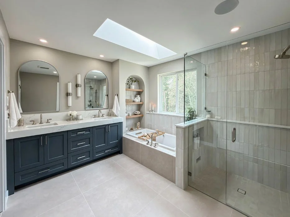 Full bathroom remodel in Sammamish Washington featuring walk-in shower, freestanding tub, skylight, and custom double vanity design