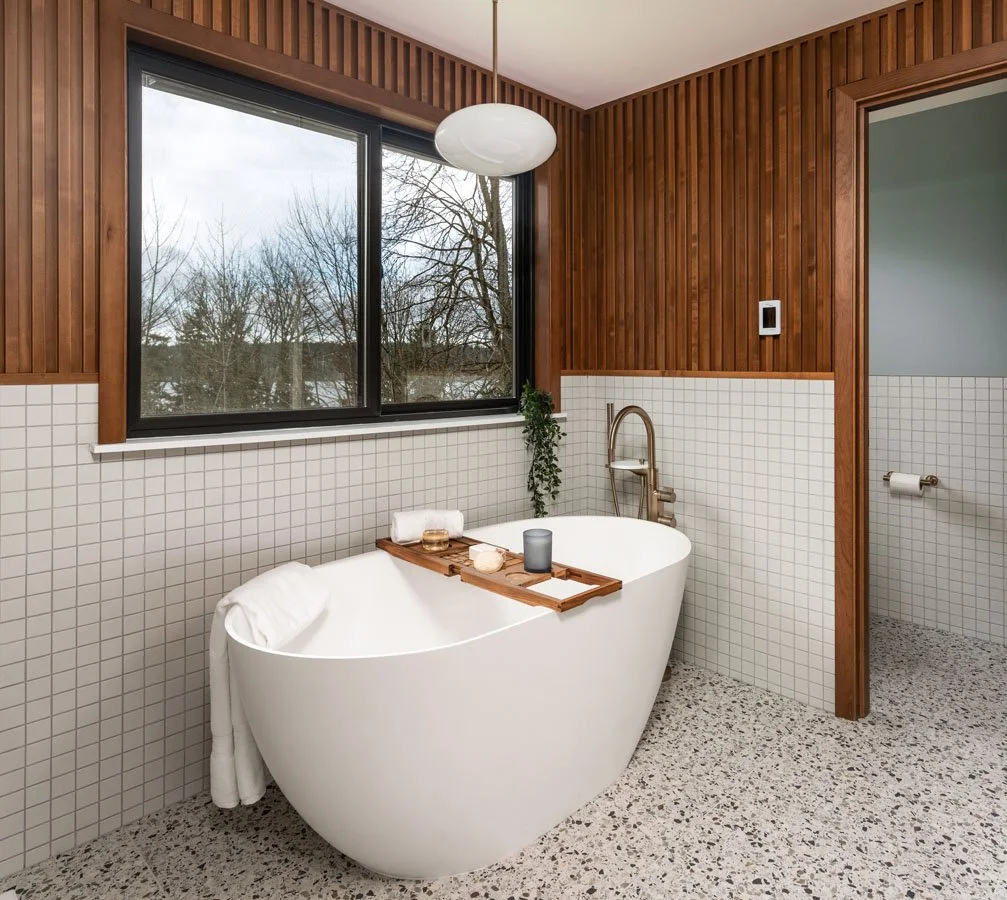 Sammamish WA bathroom remodel by a professional remodeling contractor featuring a freestanding soaking tub, wood slat accent wall, and large window overlooking Lake Sammamish