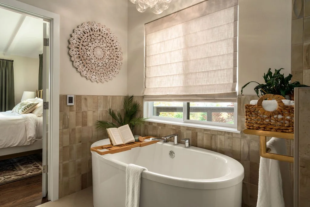 Primary bathroom remodel in a Gig Harbor home featuring a freestanding soaking tub, neutral tile surround, and spa-inspired finishes completed by a remodeling contractor.