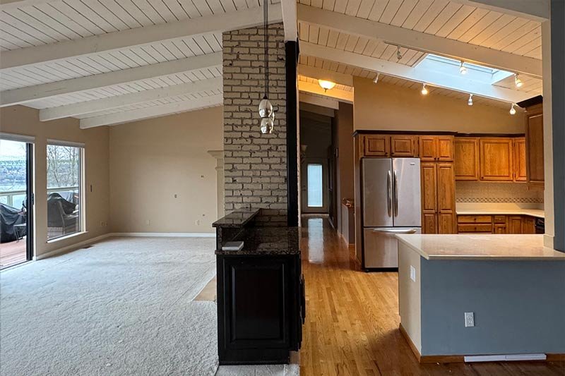 Before photo of the living room and kitchen in a Gig Harbor home remodel, showing the original layout prior to renovation by a local remodeling contractor.