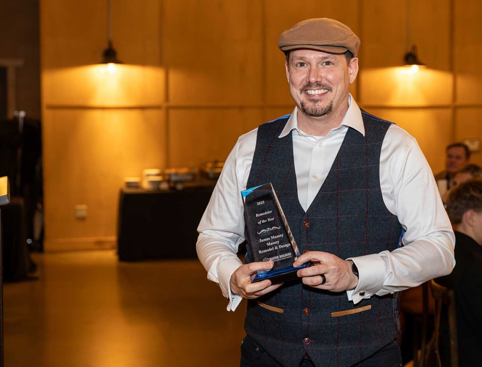 James Massey holding the Remodeler of the Year award at the Master Builders Association of Pierce County President’s Gala in Puyallup.