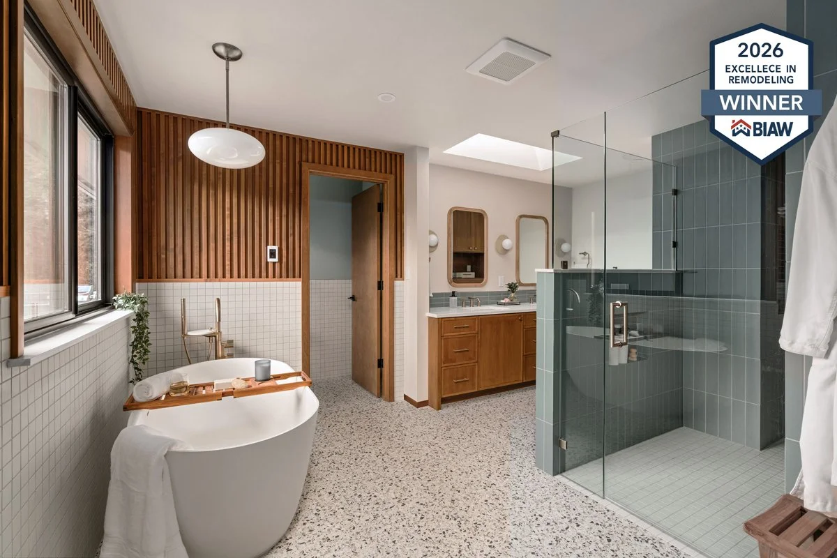 Modern bathroom renovation by Massey Remodel + Design featuring a freestanding soaking tub, walk-in glass shower, terrazzo flooring, and warm wood finishes, recognized with a 2026 Excellence in Remodeling Award.