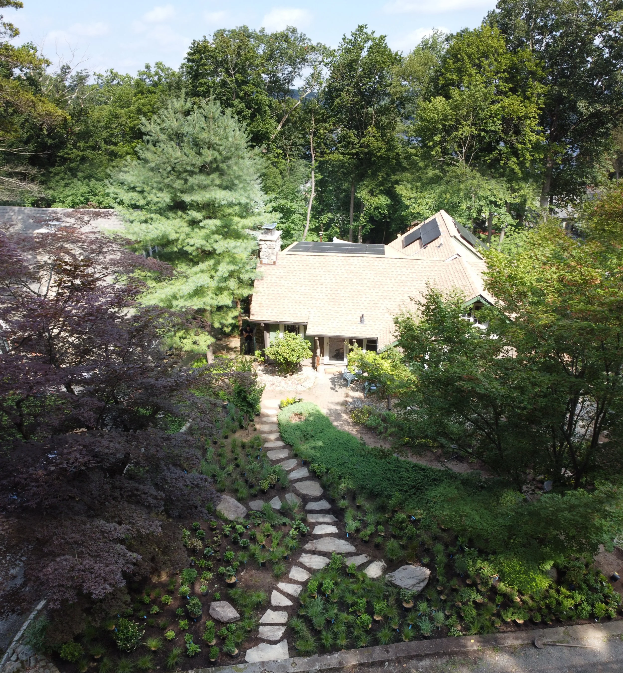 A Path Takes Shape. Aerial view of the newly installed flagstone path winding through fresh plantings and boulders.