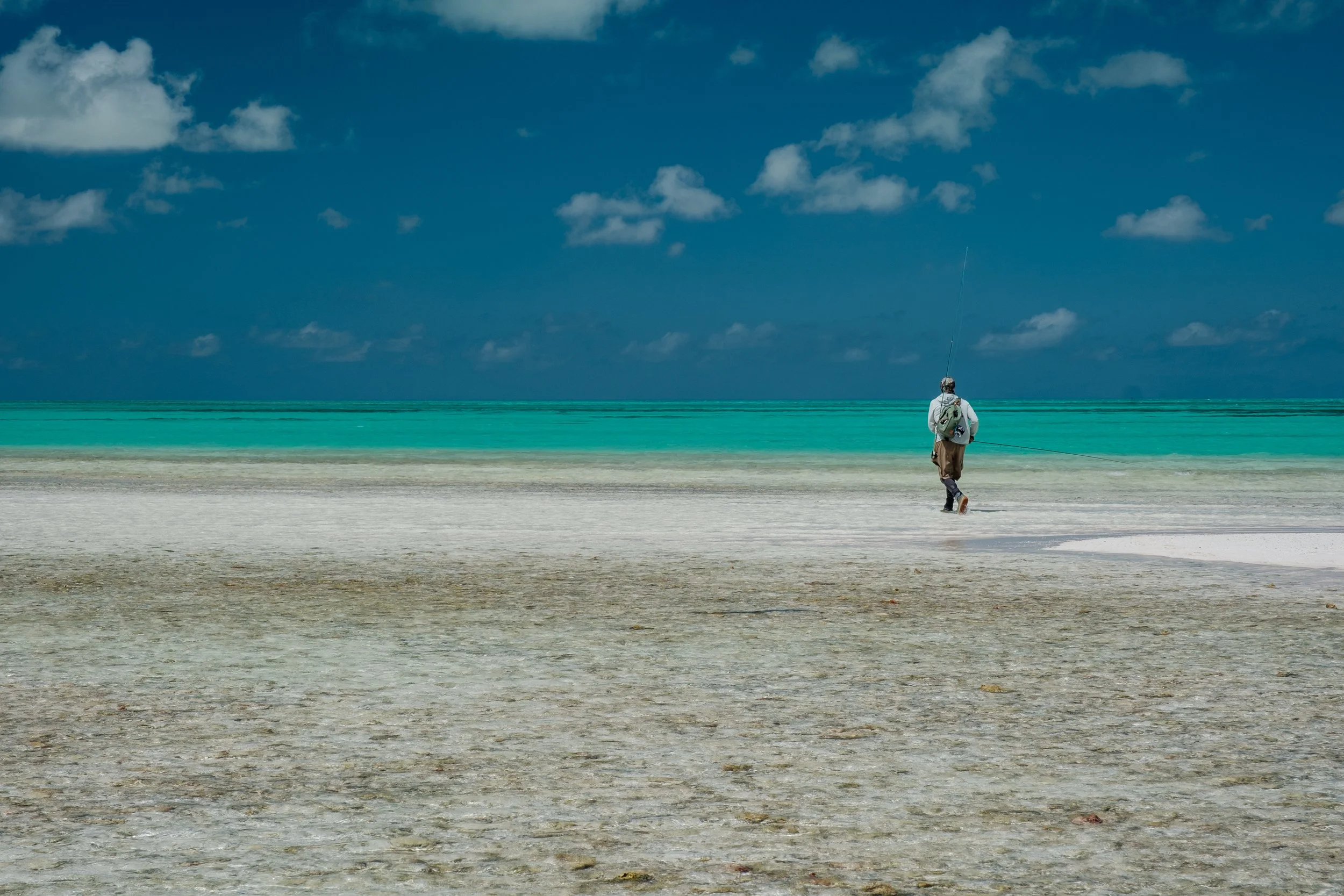 An angler walks the flats on Fanning Island