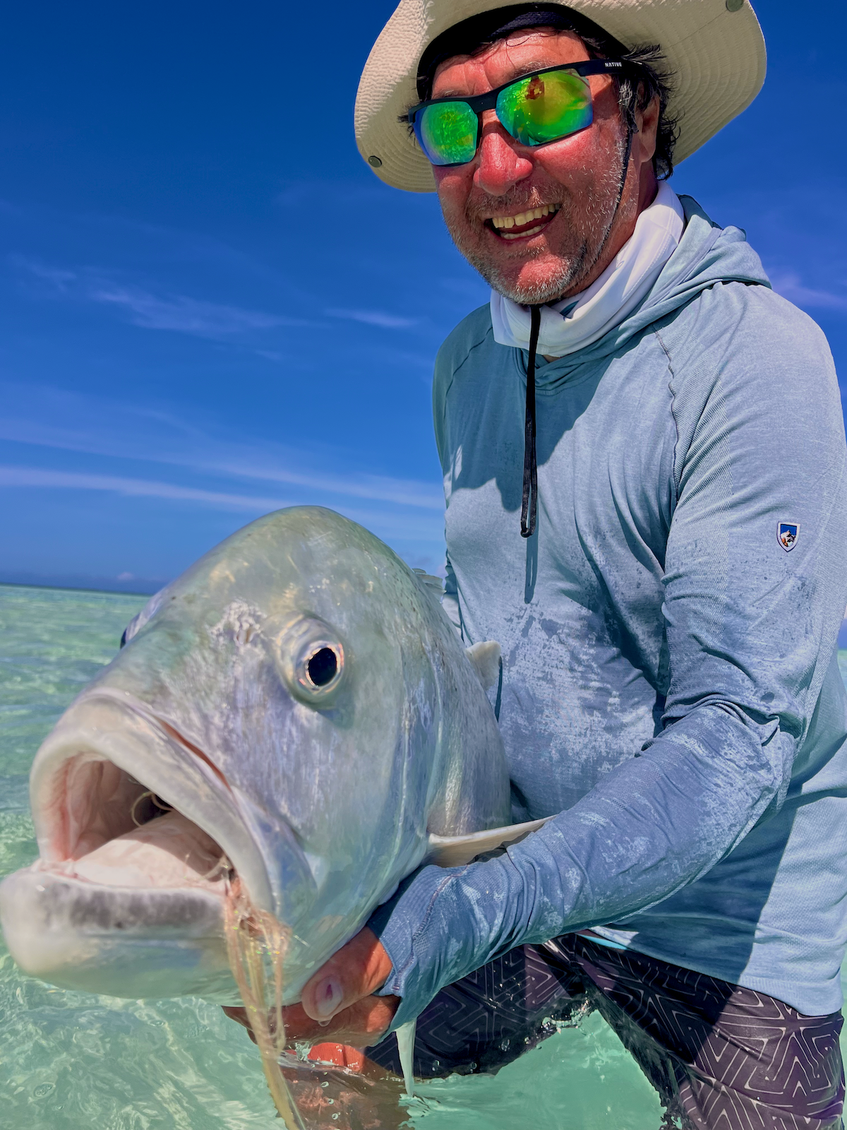 Angler holds up trophy Giant Trevally on Fanning Island