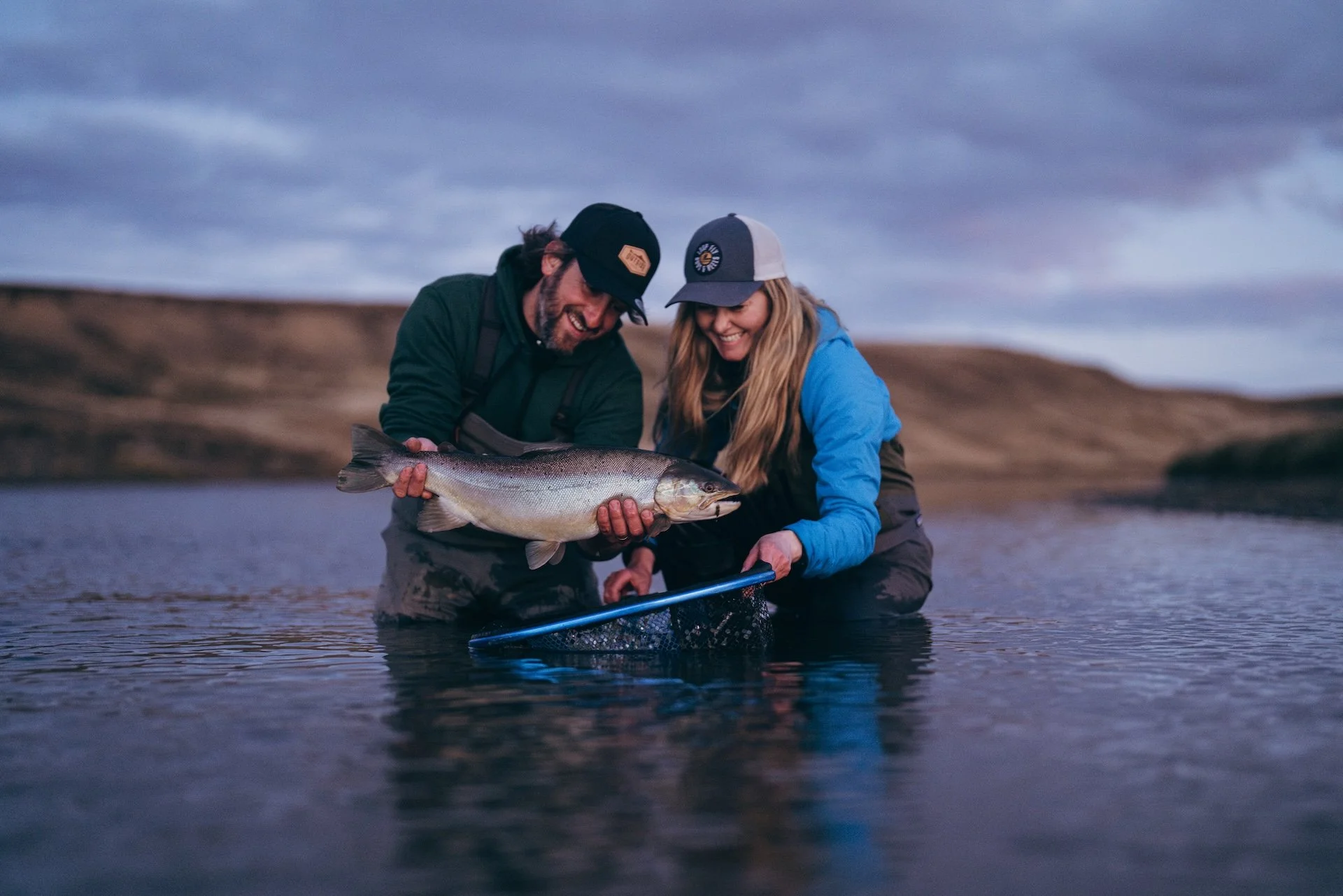 guide and angler celebrate the catch of salmon on the Río Menéndez