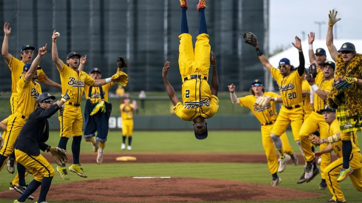 Savannah Bananas players dancing around a player that did a backflip