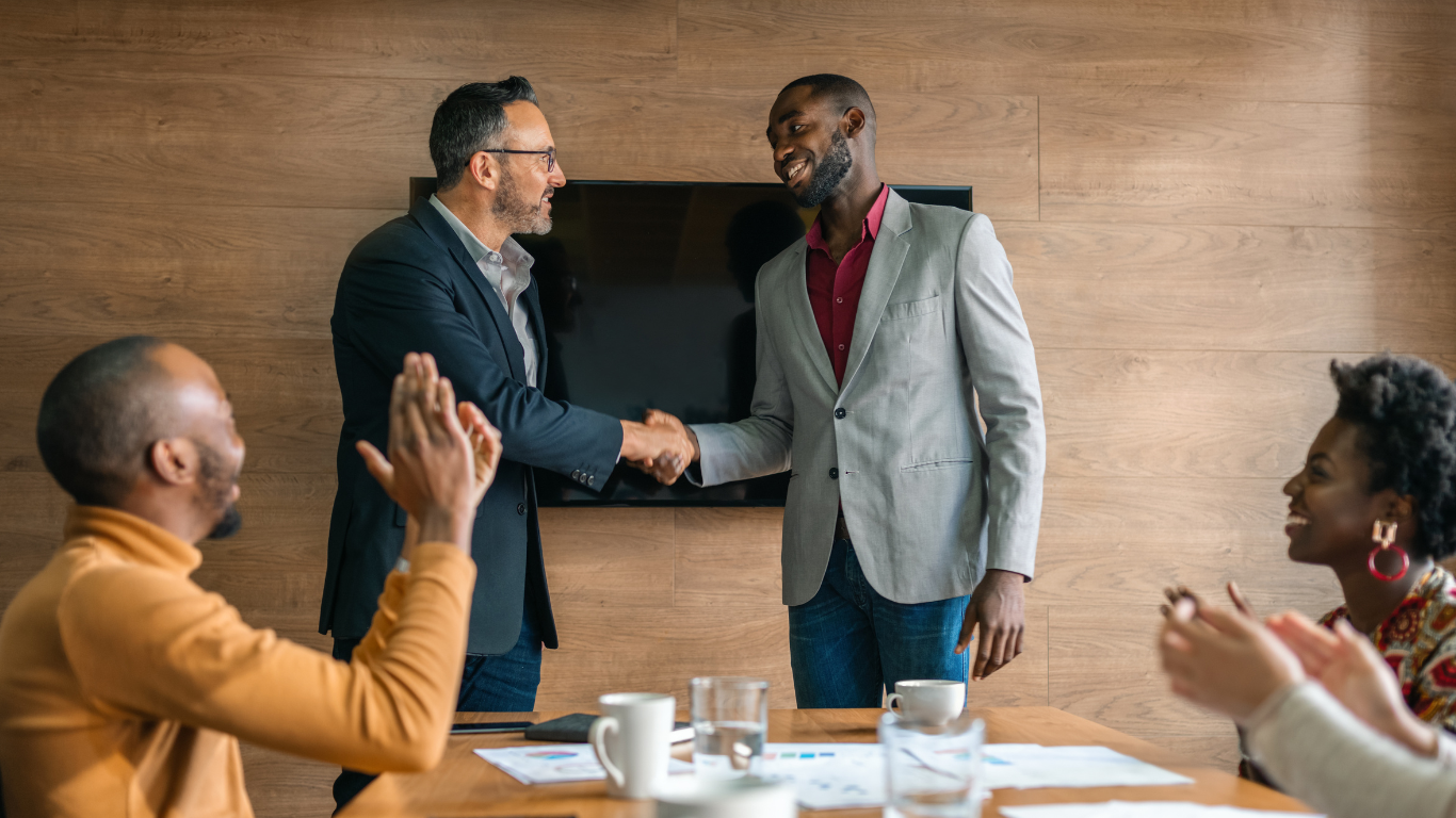 Fundraising Coach Shaking Hand with Executive Director after conducting a training in a Nonprofit Board Room