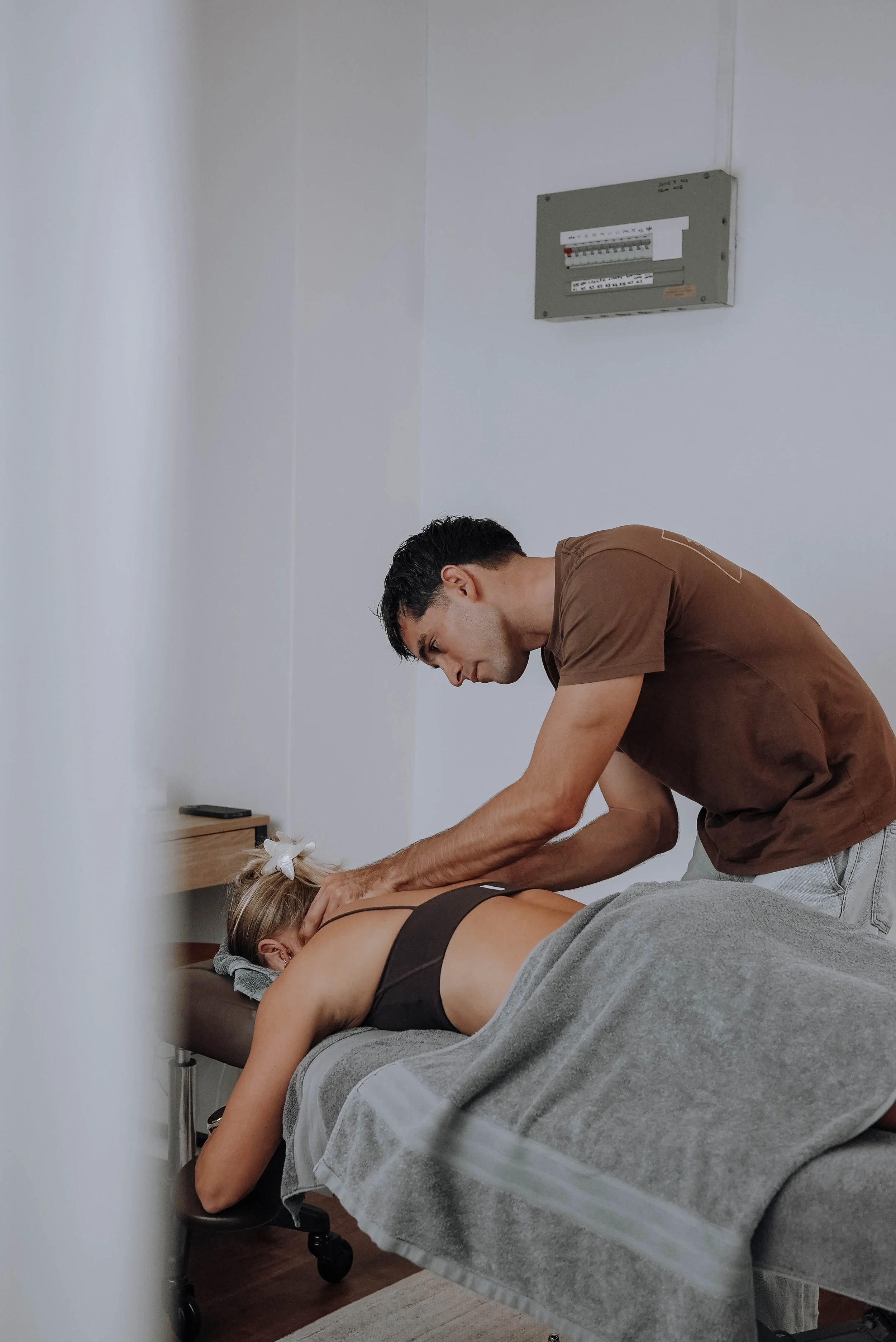 Osteopath treating a patient's neck and upper back to relieve neck-related (cervicogenic) headaches