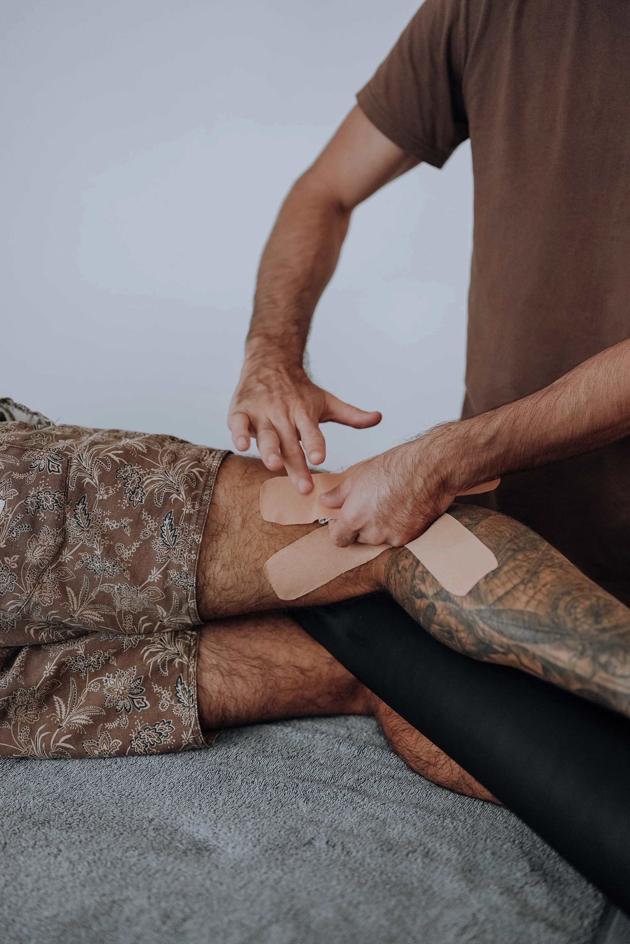 Kinesiology taping applied to the knee for a sporting injury at Medela Osteopathy & Co in Tweed Heads