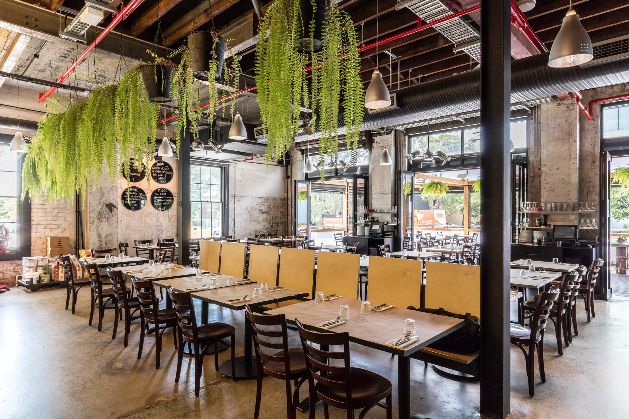 Da Mario dining room in Rosebery Sydney with the wood fired oven visible during evening service