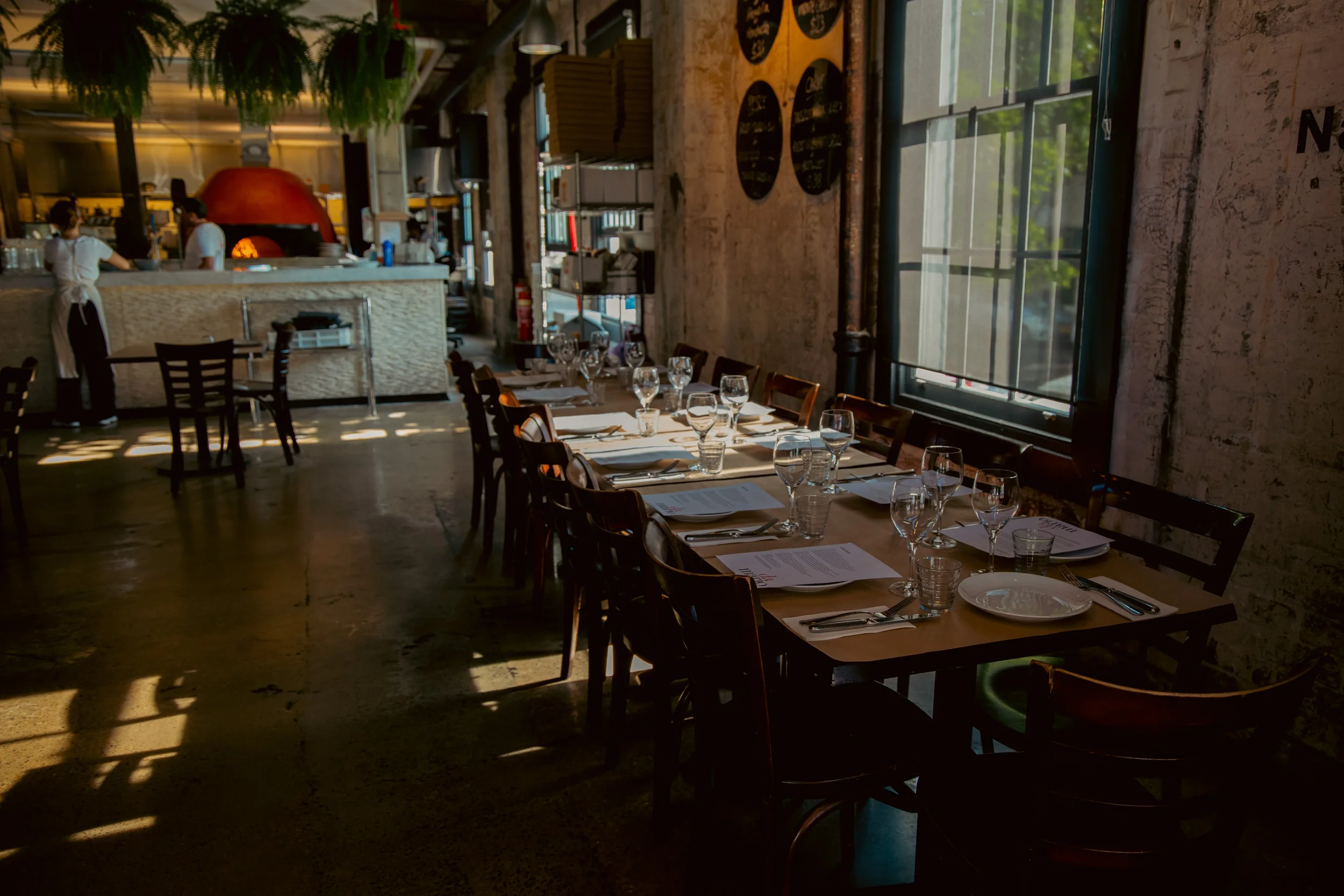 Da Mario Rosebery interior with red wood-fired oven and hanging ferns ideal for Sydney bridal showers