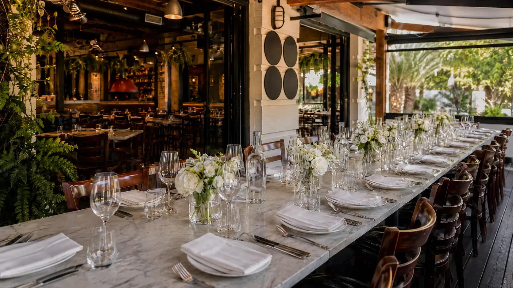 Long table set for a family christening celebration on a restaurant terrace in Rosebery
