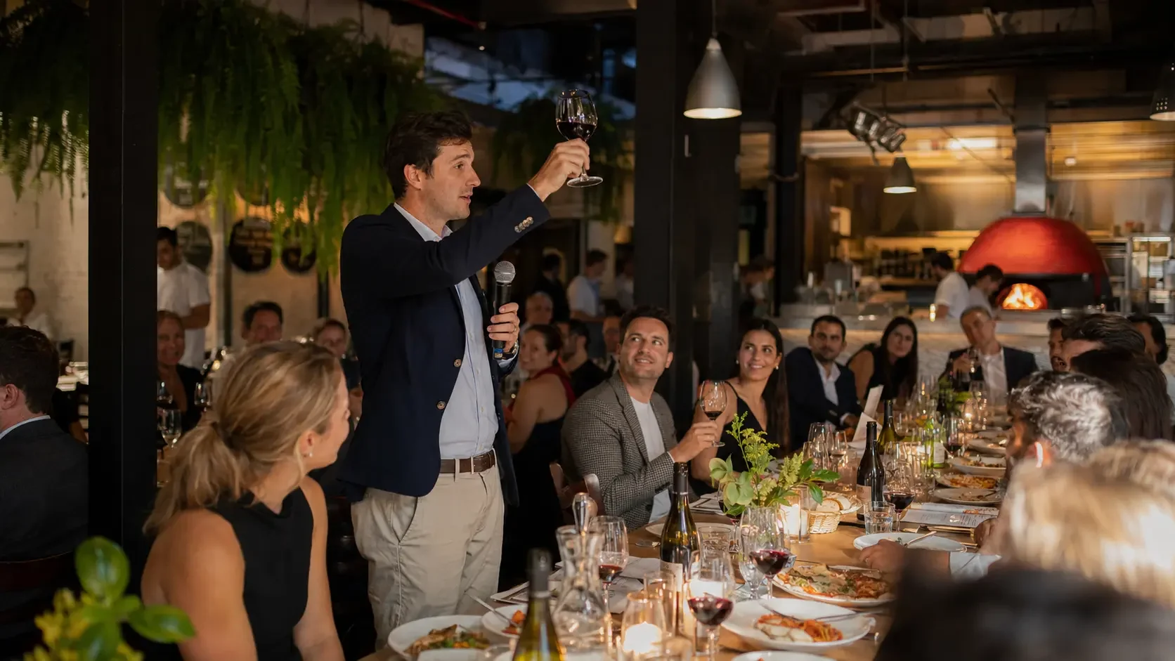 Speech with microphone at a large group dinner in a Sydney restaurant