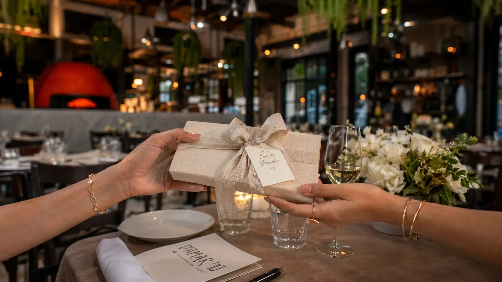 A thoughtfully wrapped bridal shower gift with a handwritten card, reflecting relationship-based gift budgeting