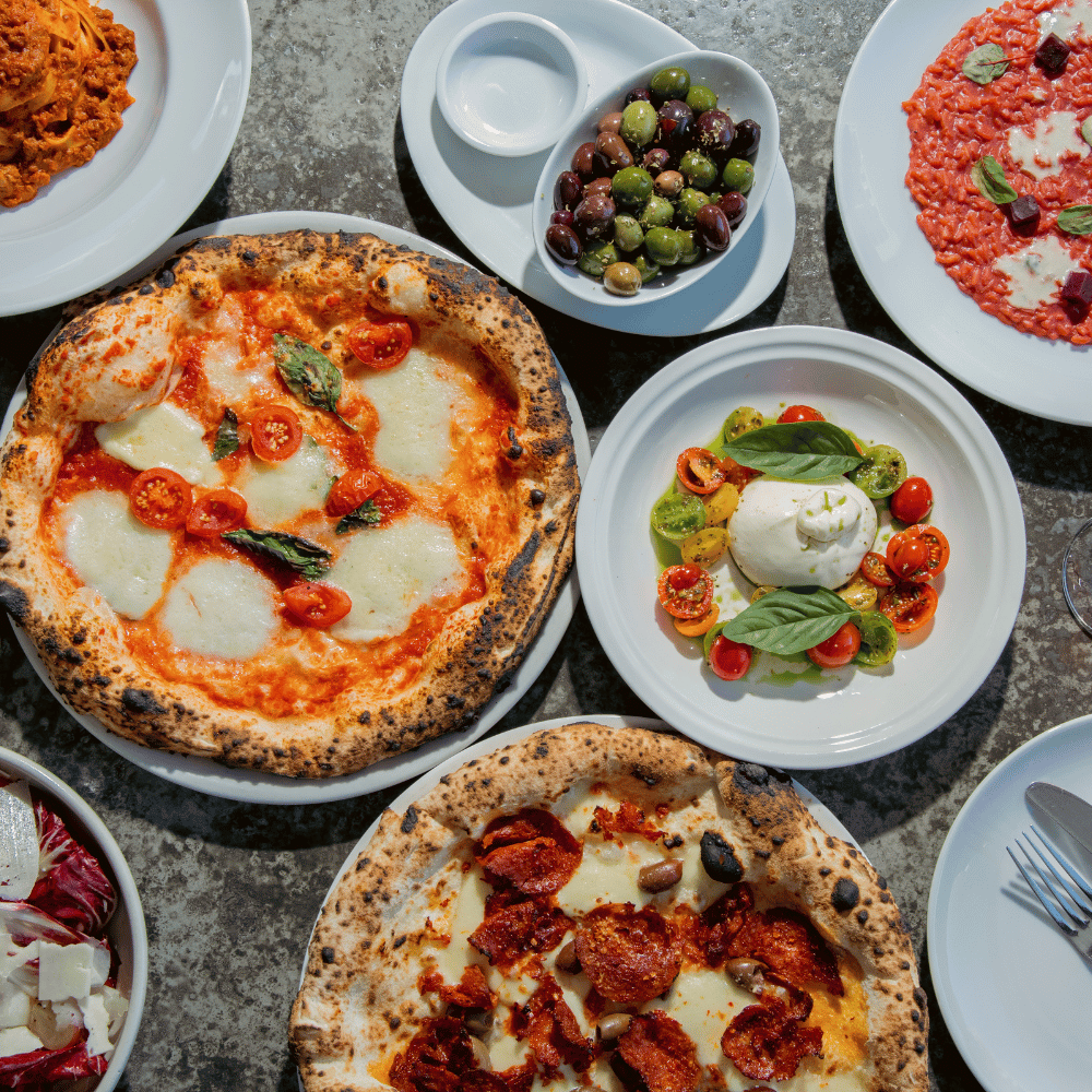 Woodfired pizzas with basil, sausage and olives at Da Mario Italian Restaurant Rosebery Sydney