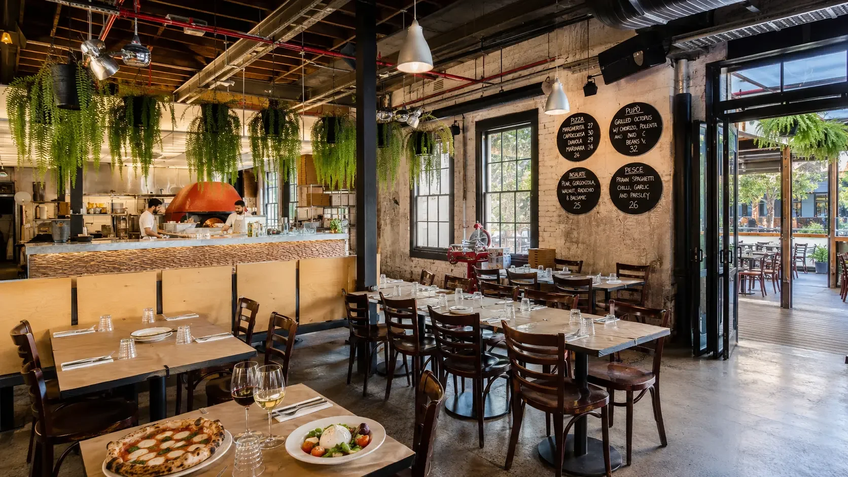 Da Mario Rosebery interior with wood-fired pizza oven, exposed brick walls and long shared dining tables