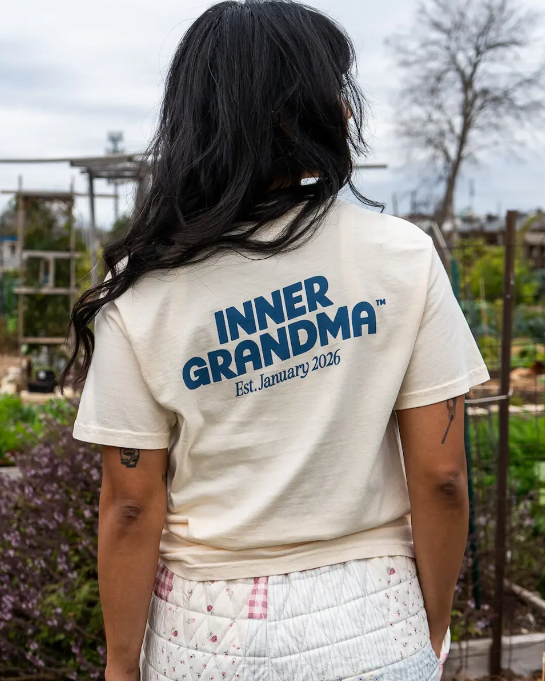 A person wearing an inner grandma logo tee