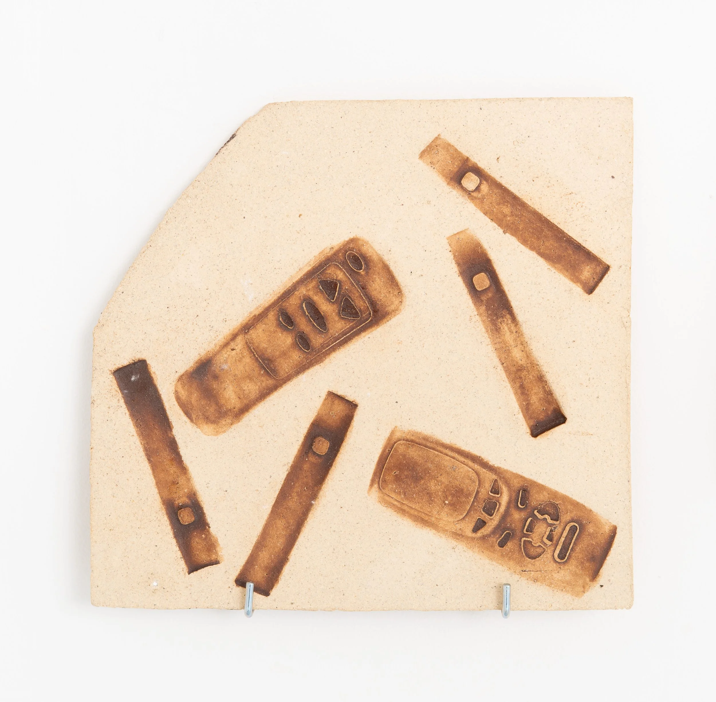 Jared Goldfischer,  Vape and Remote Fossil , 2026. White stoneware and glaze, 10 x 10 in.