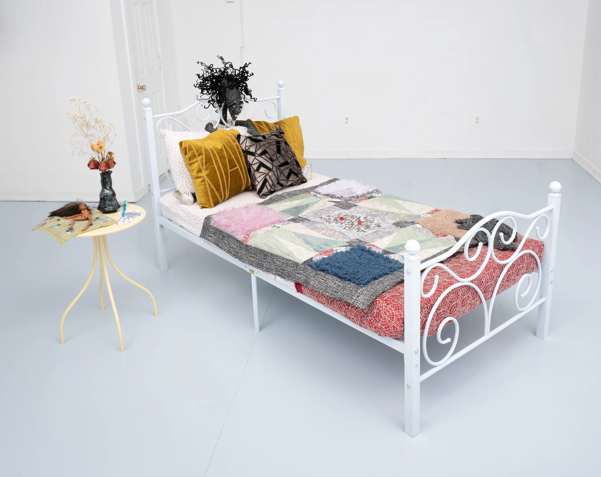 Imani Campbell, "Fracts Cradle, Altar," 2026. Installation with multiple artist objects on bed.