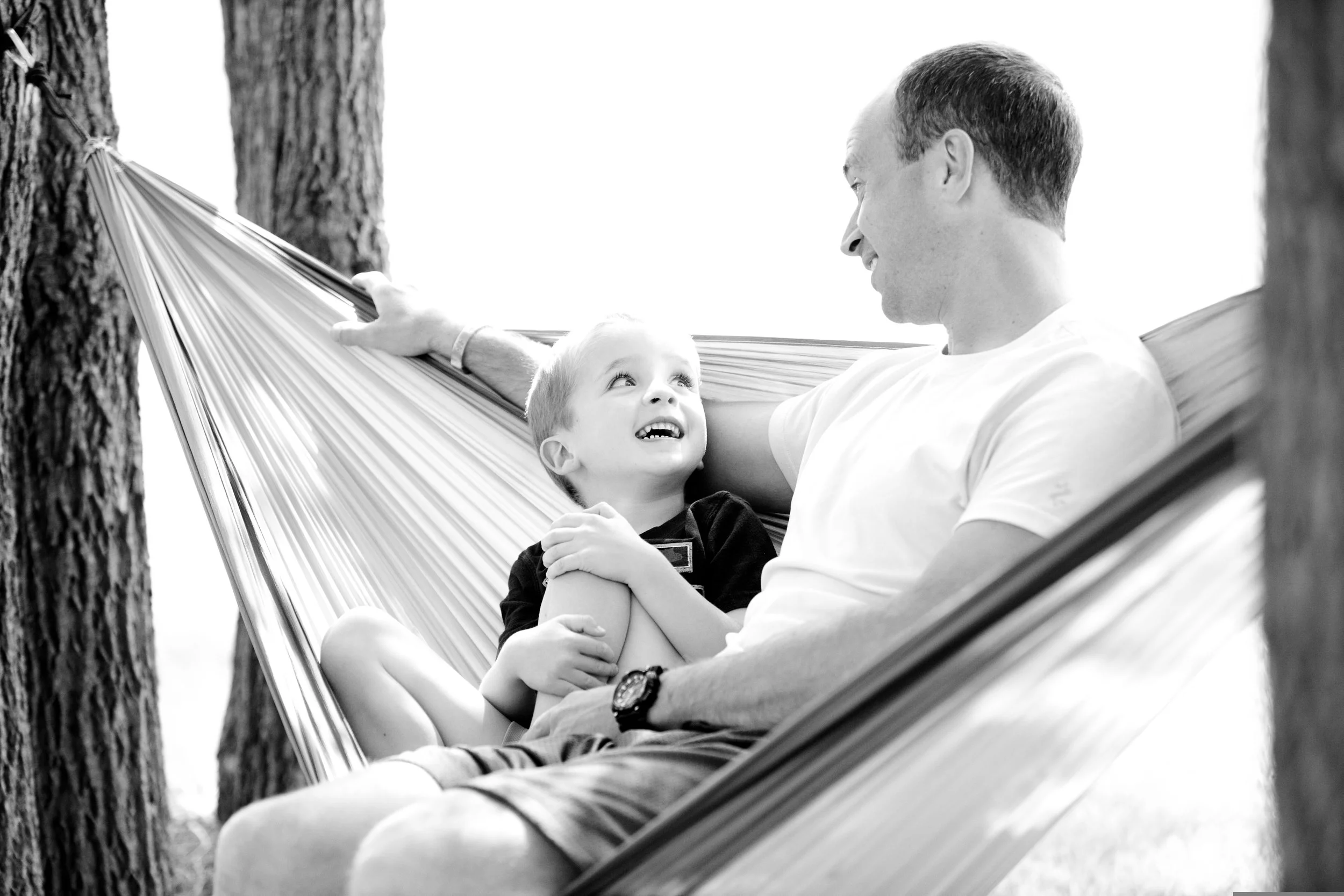 Parent encouraging a bilingual child to speak their home language during a relaxed conversation