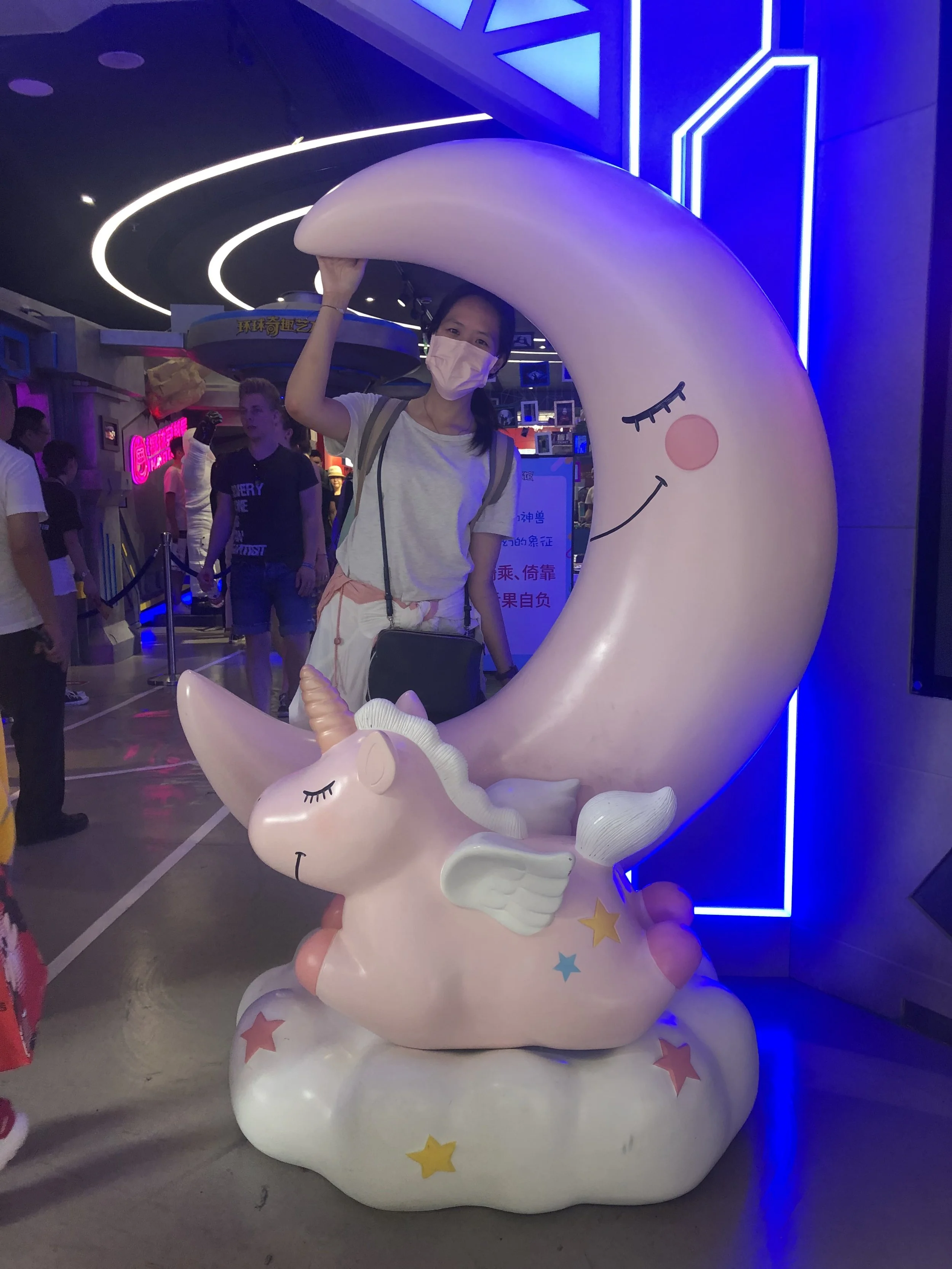 Dr Charlene with a crescent moon, unicorn on a cloud statue