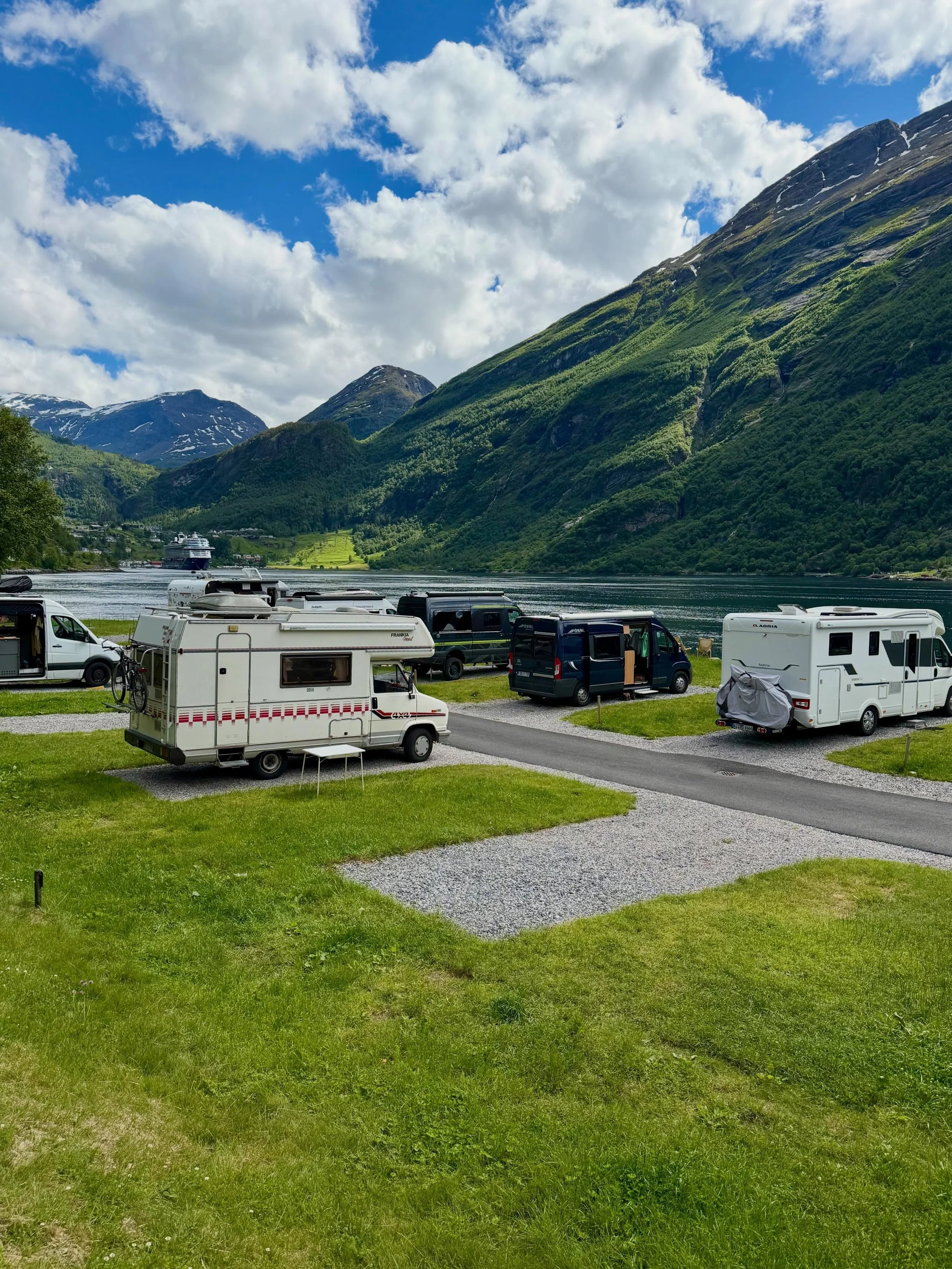 The sun is shining, it&rsquo;s 19&deg;C, and there were only two spots left at Geirangerfjorden Feriesenter right by the fjord &mdash; so an early stop it was today.

What a place! Parked right on the waterfront with stunning views of the fjord, the 
