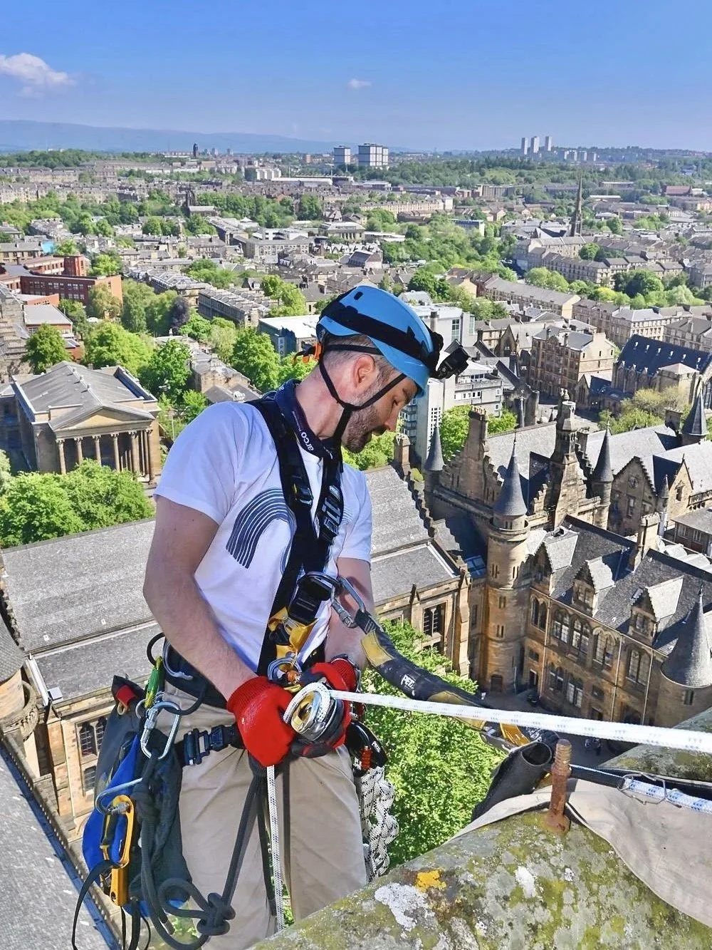 Rope access technician on ropes in the city